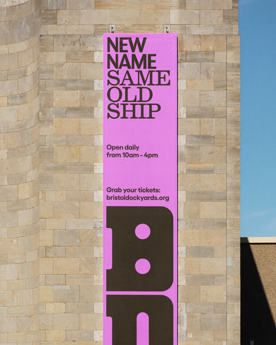 Skinny poster in pink showing Bristol Dockyards signage by HOW+HOW