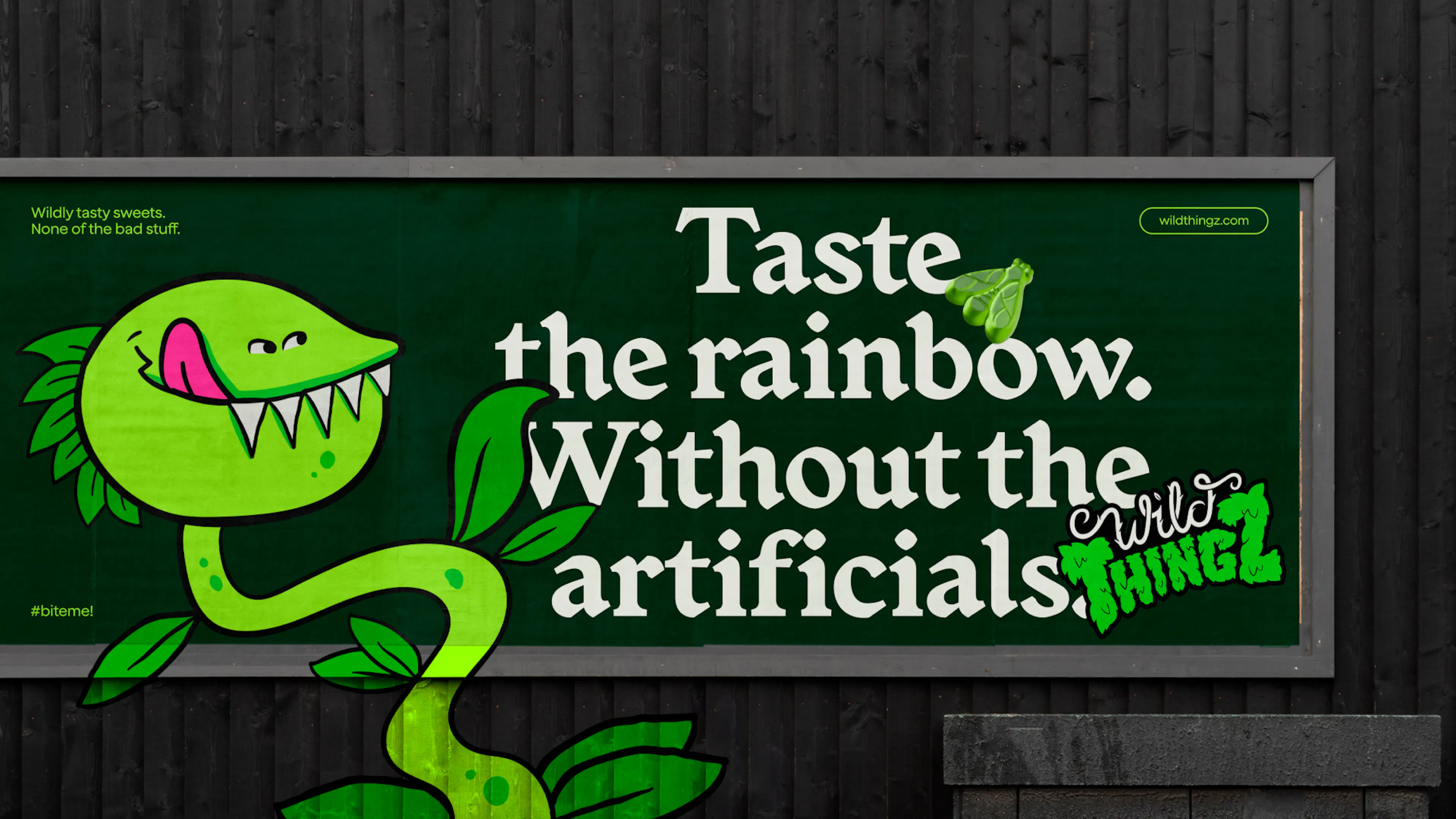 Wild Thingz billboard reading 'Taste the rainbow. Without the artificials.' with Vee the Venus flytrap