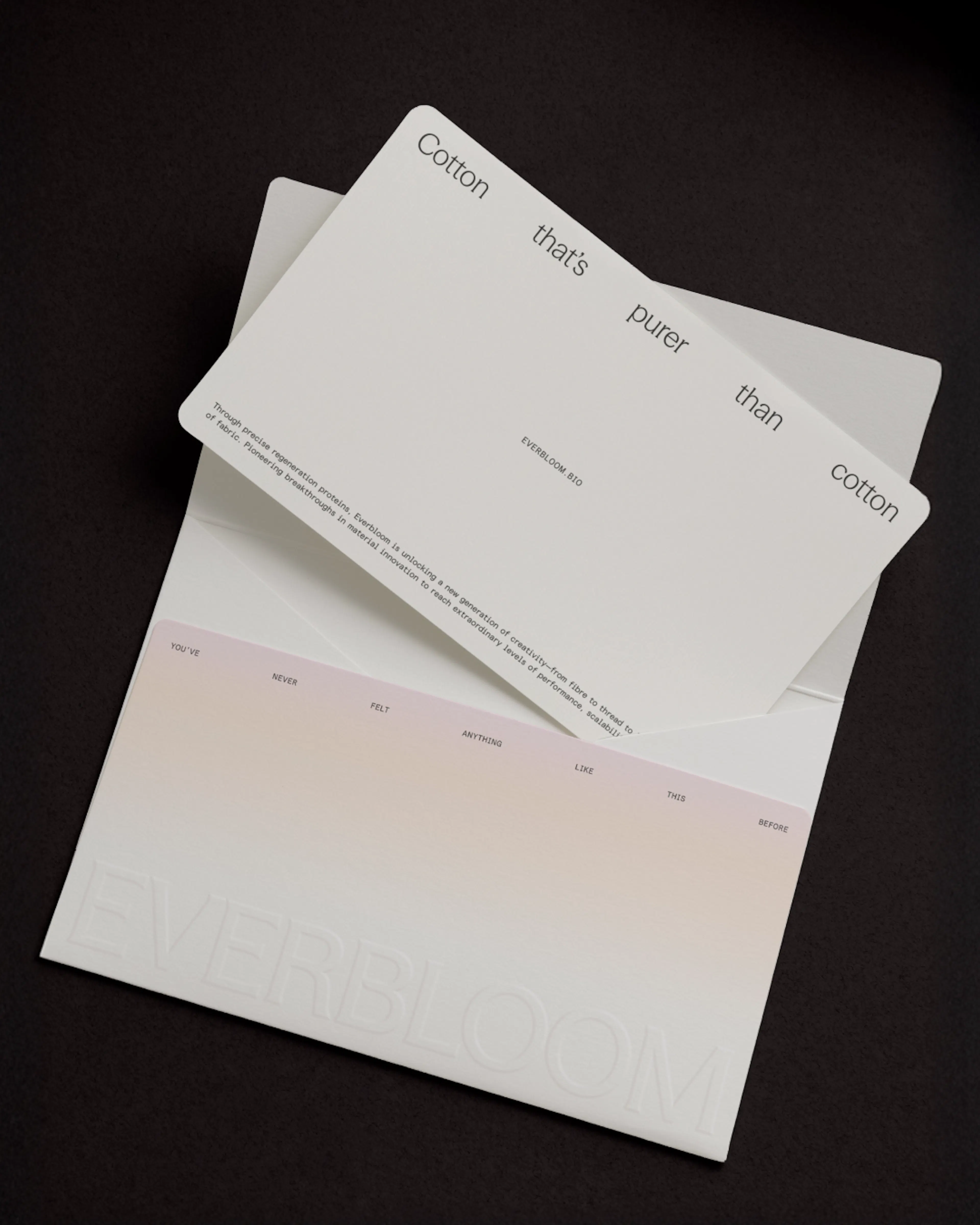 Everbloom card slipping out of a pale gradient envelope on black