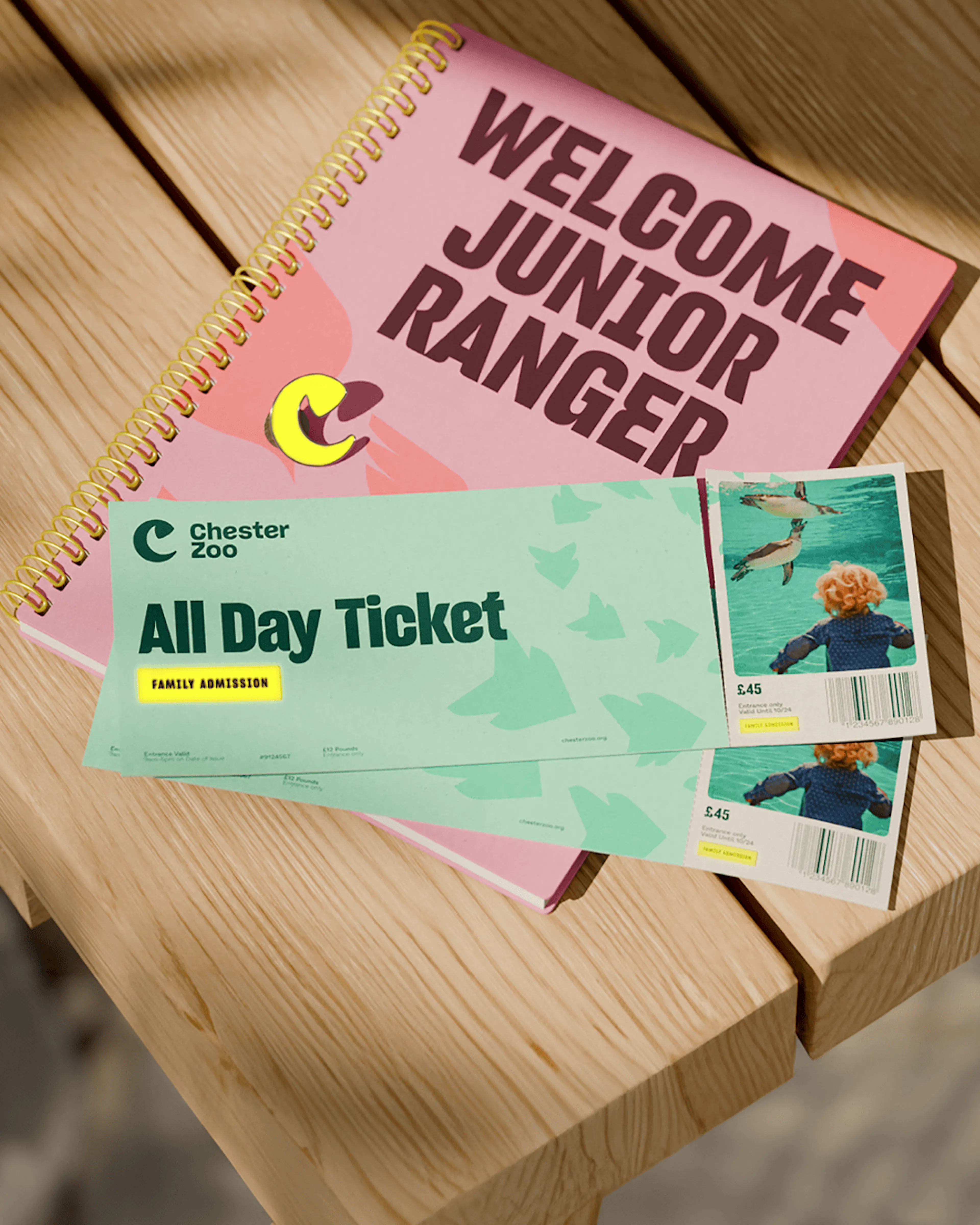 Chester Zoo All Day Ticket and 'Welcome Junior Ranger' notebook on a picnic table