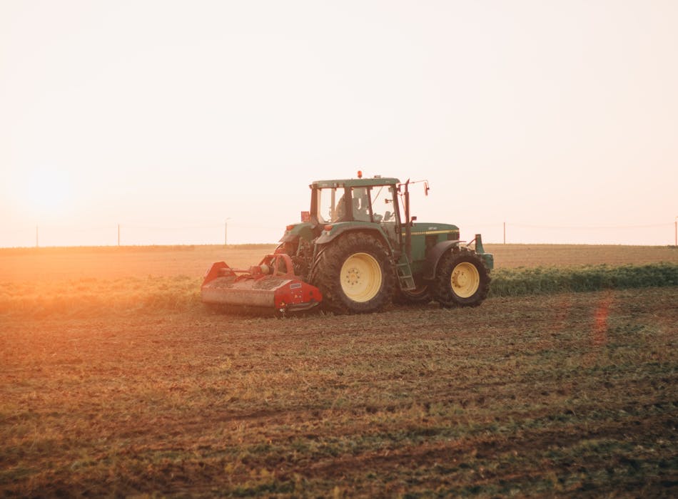 Tractor working in a field. Photo by Sharon Rosseels on Unsplash