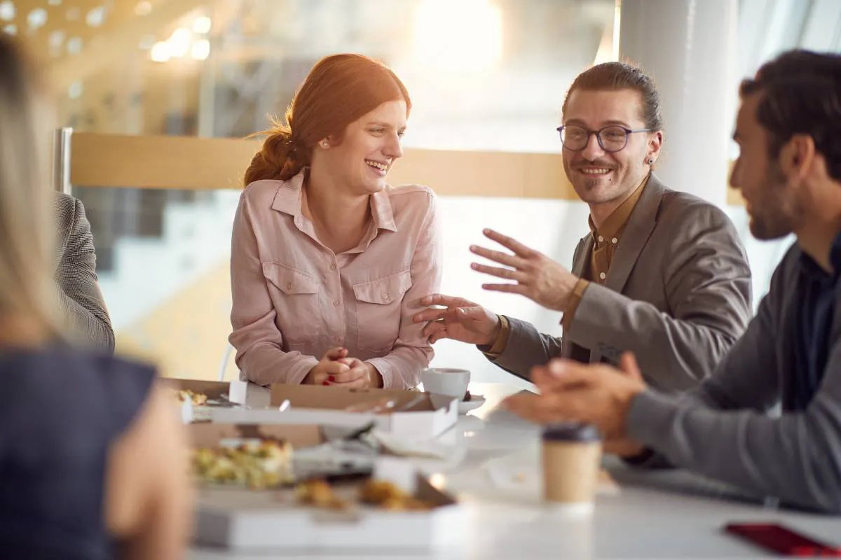 Coworkers connecting over eating a workplace lunch