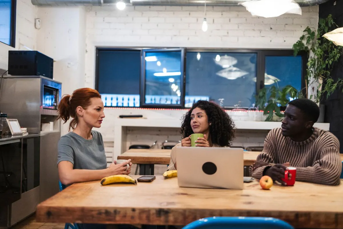 Coworkers talking in an employee kitchen