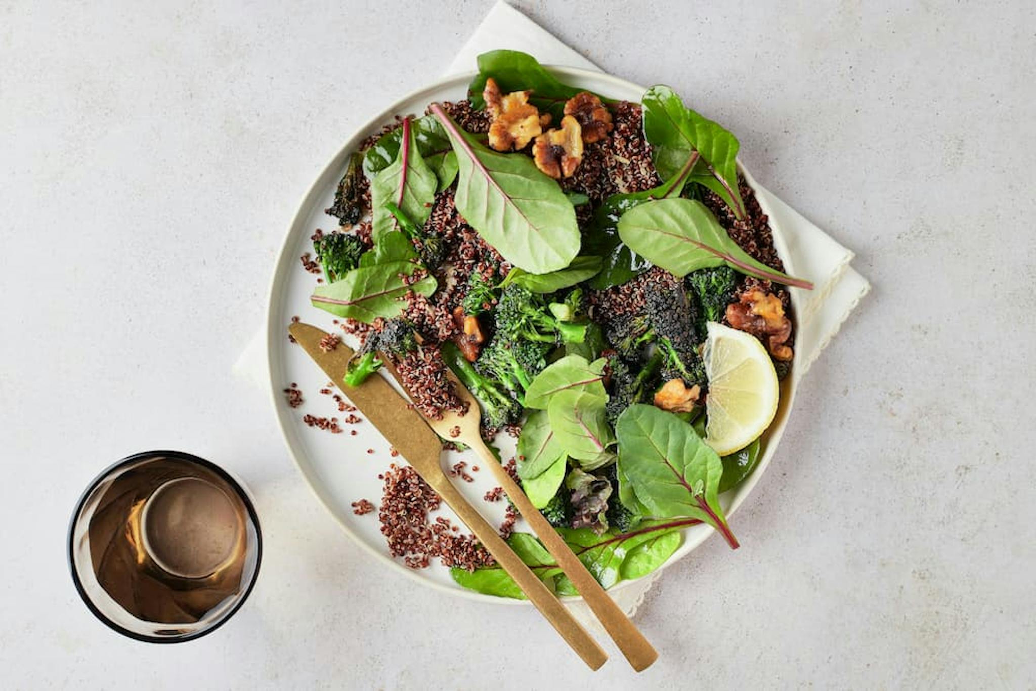 Healthy dish with red quinoa, green leaves, and lemon. Ideal for a balanced and nutritious diet