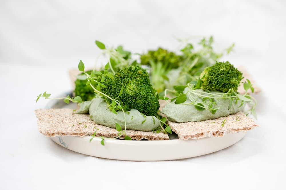 Healthy dish with broccoli, green pasta, and fresh herbs