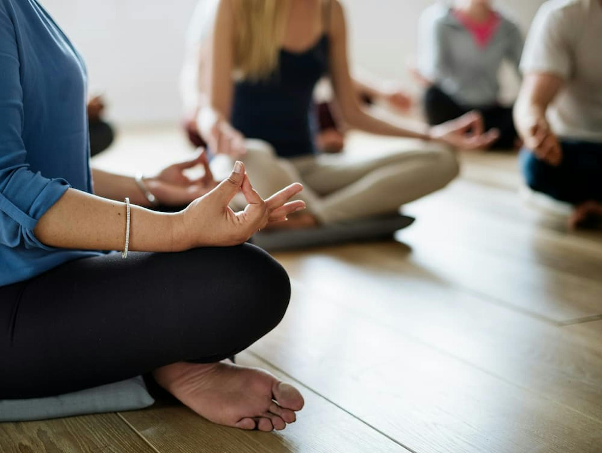 Group of people meditating in a calm environment, practicing yoga and seeking relaxation and inner peace.