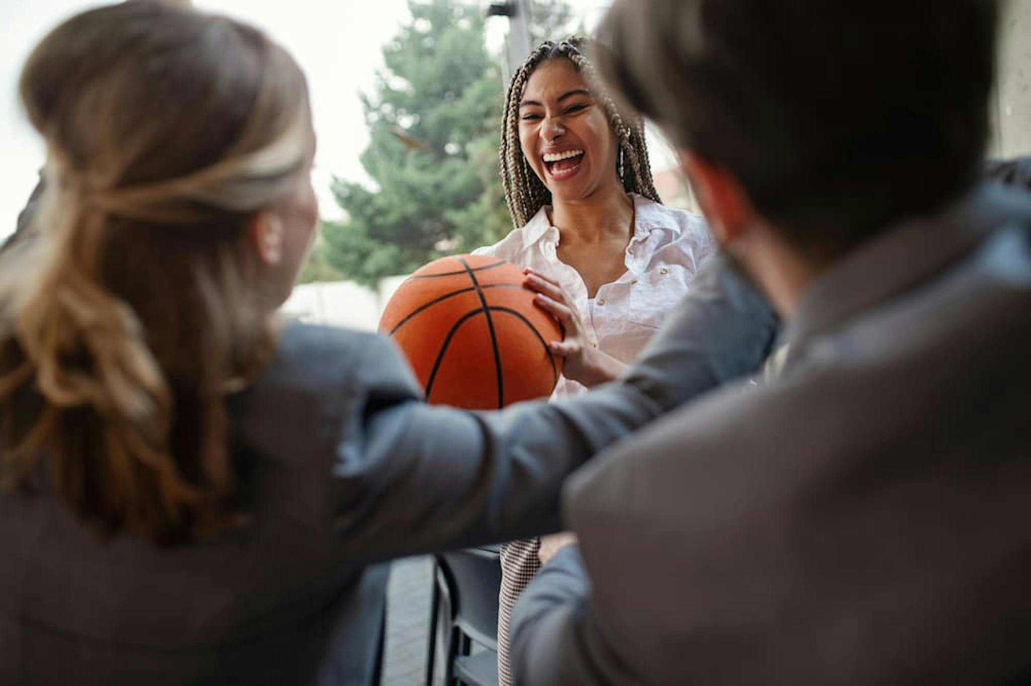 Office professionals playing basketball at March madness