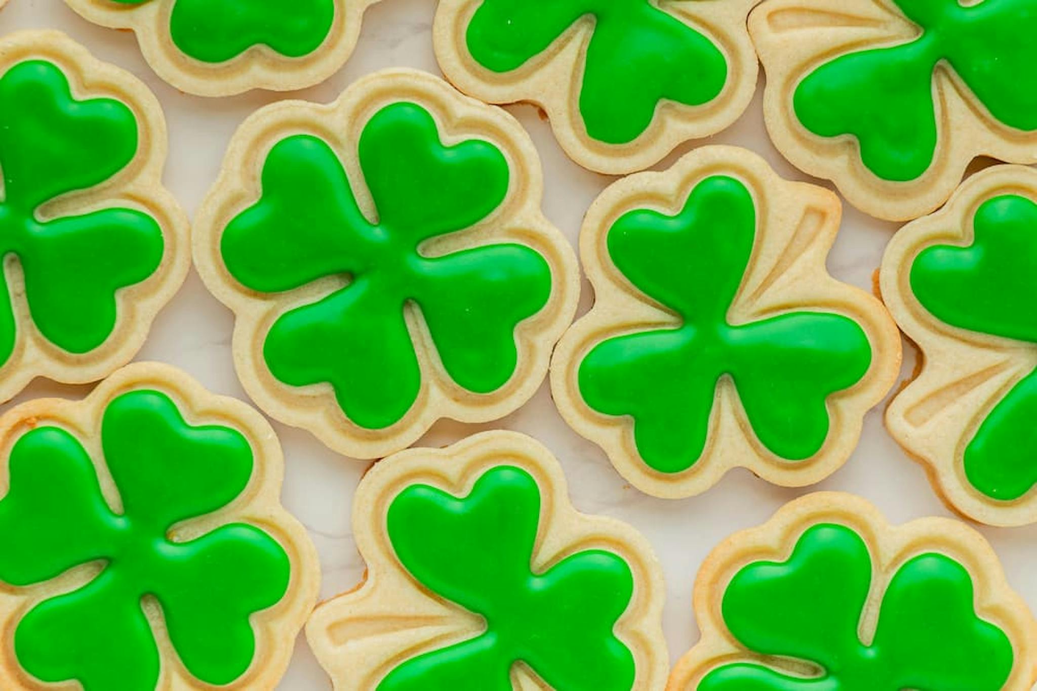 Decorated cookies in the shape of green shamrocks, perfect for celebrating St. Patrick's Day and bringing good luck.