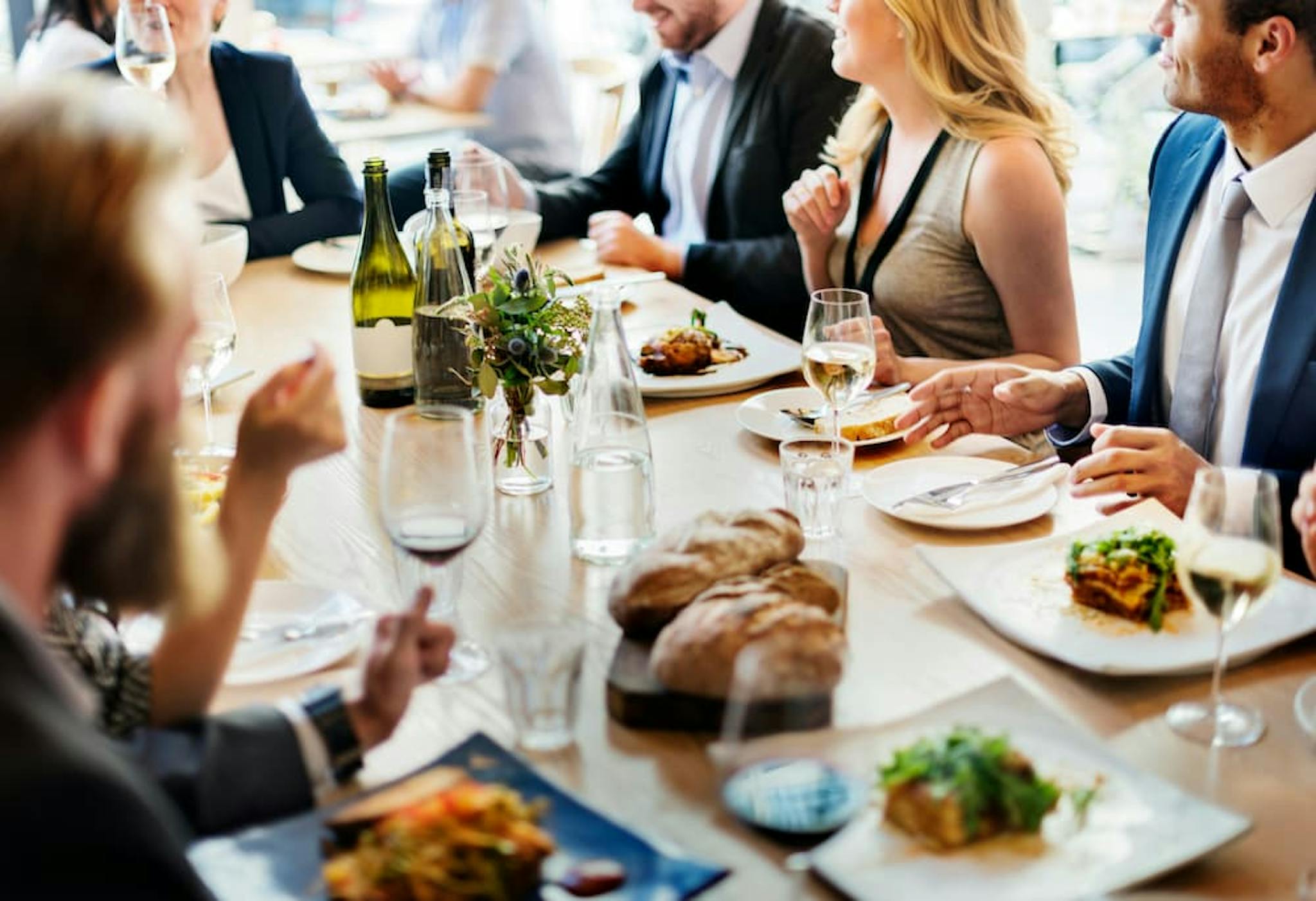 A group of colleagues enjoying a meal together at a restaurant.