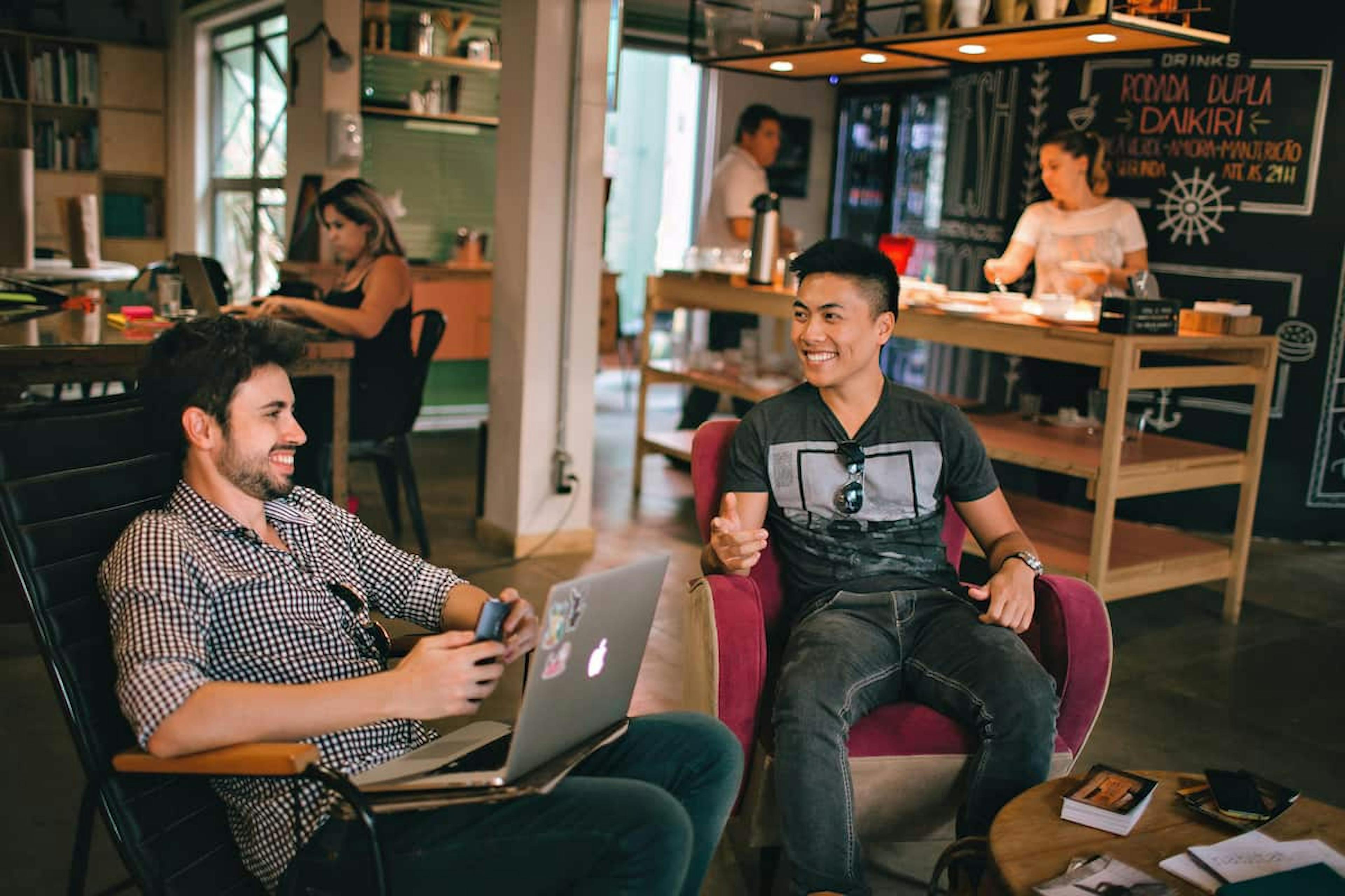 A photograph of people casually chatting in a work environment.