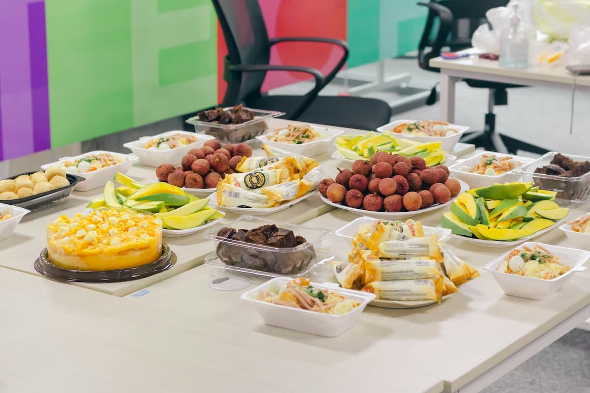 Colorful buffet setup in office showing benefits of corporate catering with Picnic for casual and enjoyable team events.