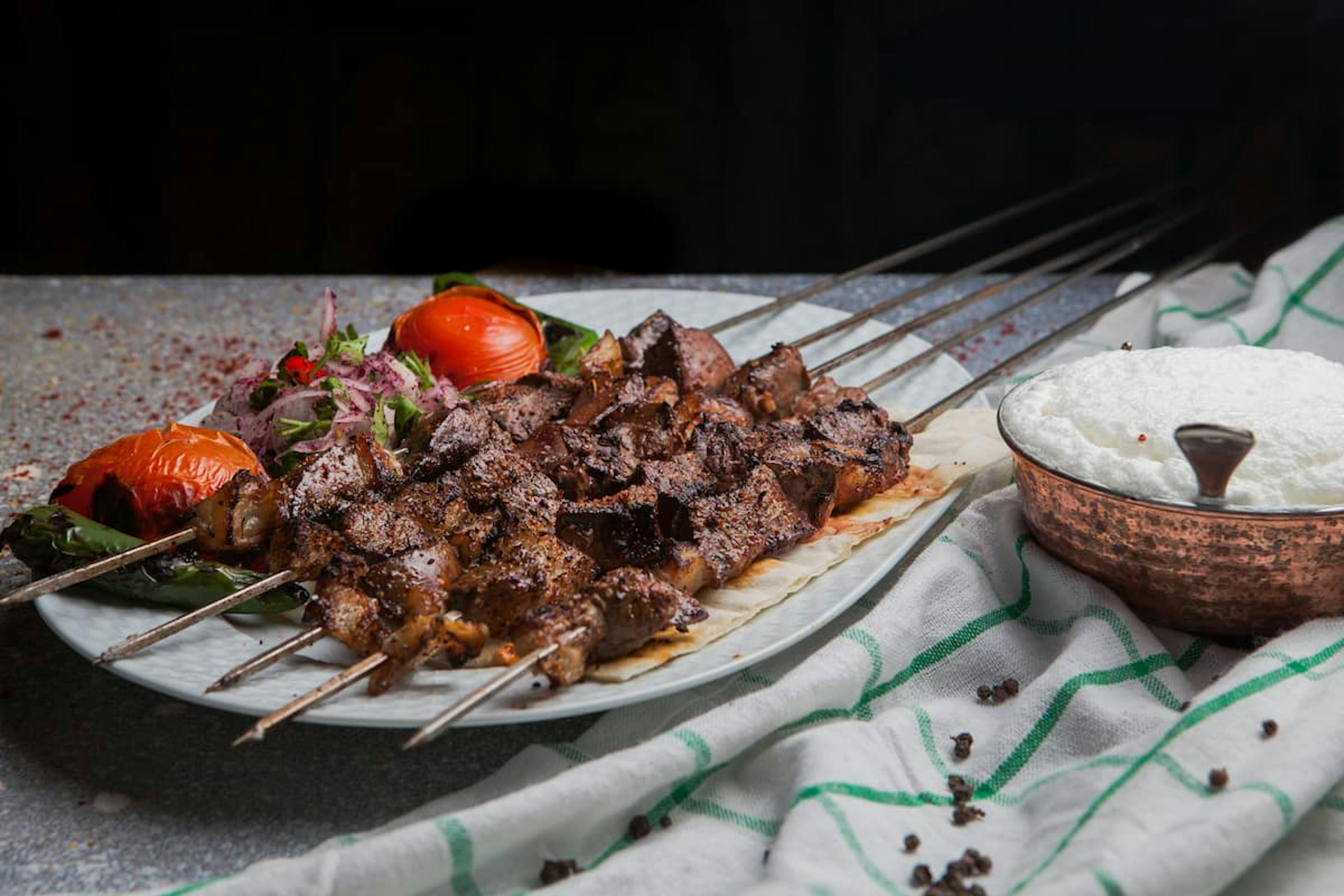 Grilled meat skewers with rice and vegetables, a savory option for food delivery in Irvine.