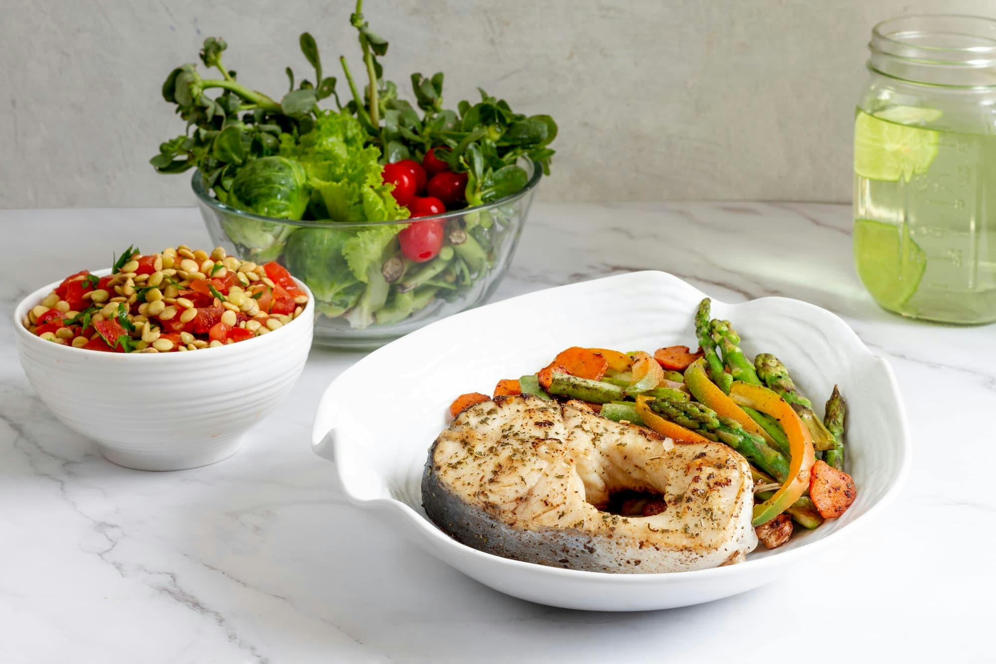 Healthy meal with grilled fish and veggies, perfect for deciding when to switch to bulk meal orders for your diet plan.