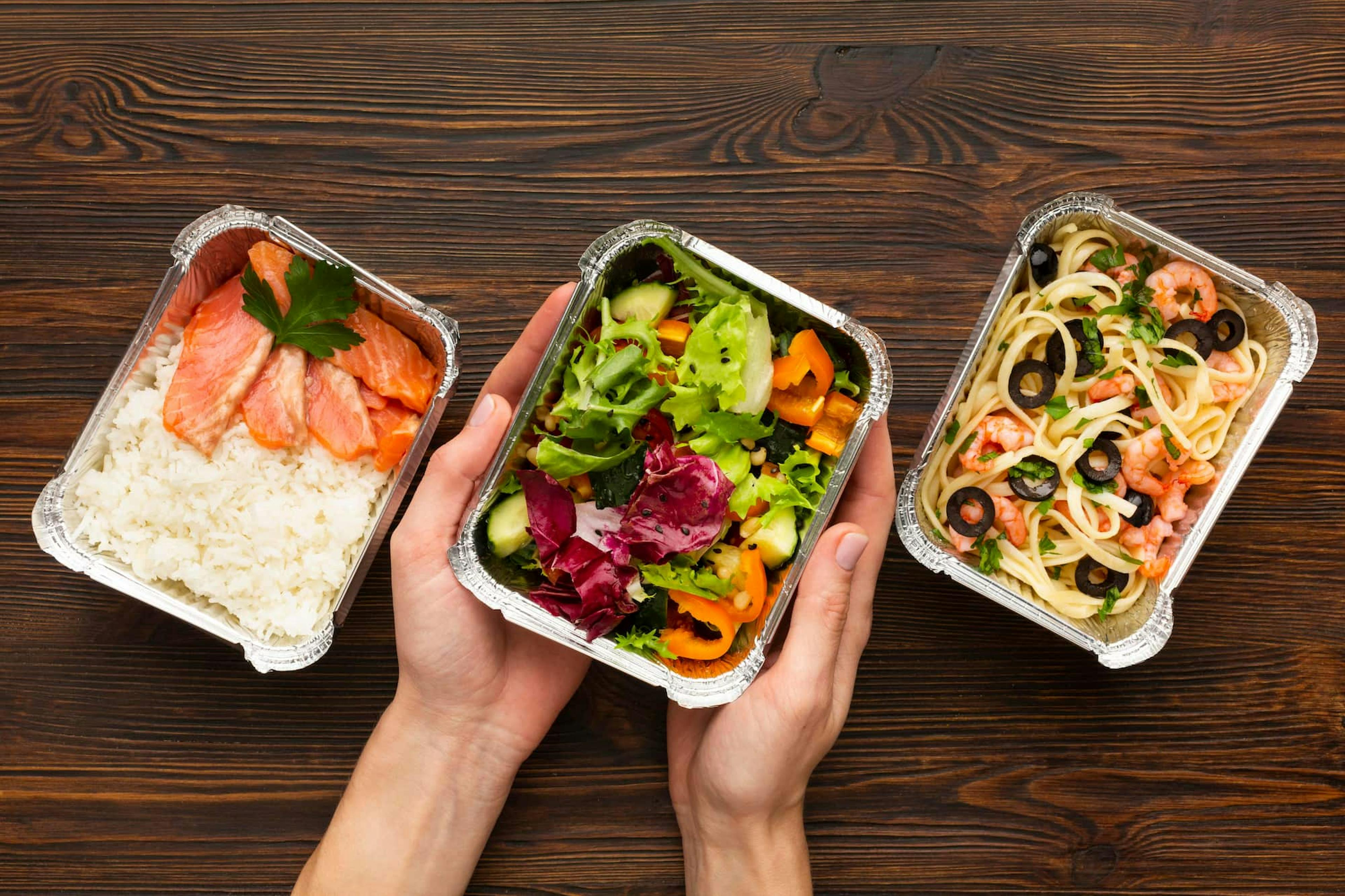 Healthy lunch options in takeout containers illustrating centralized meal ordering benefits for convenience and variety.
