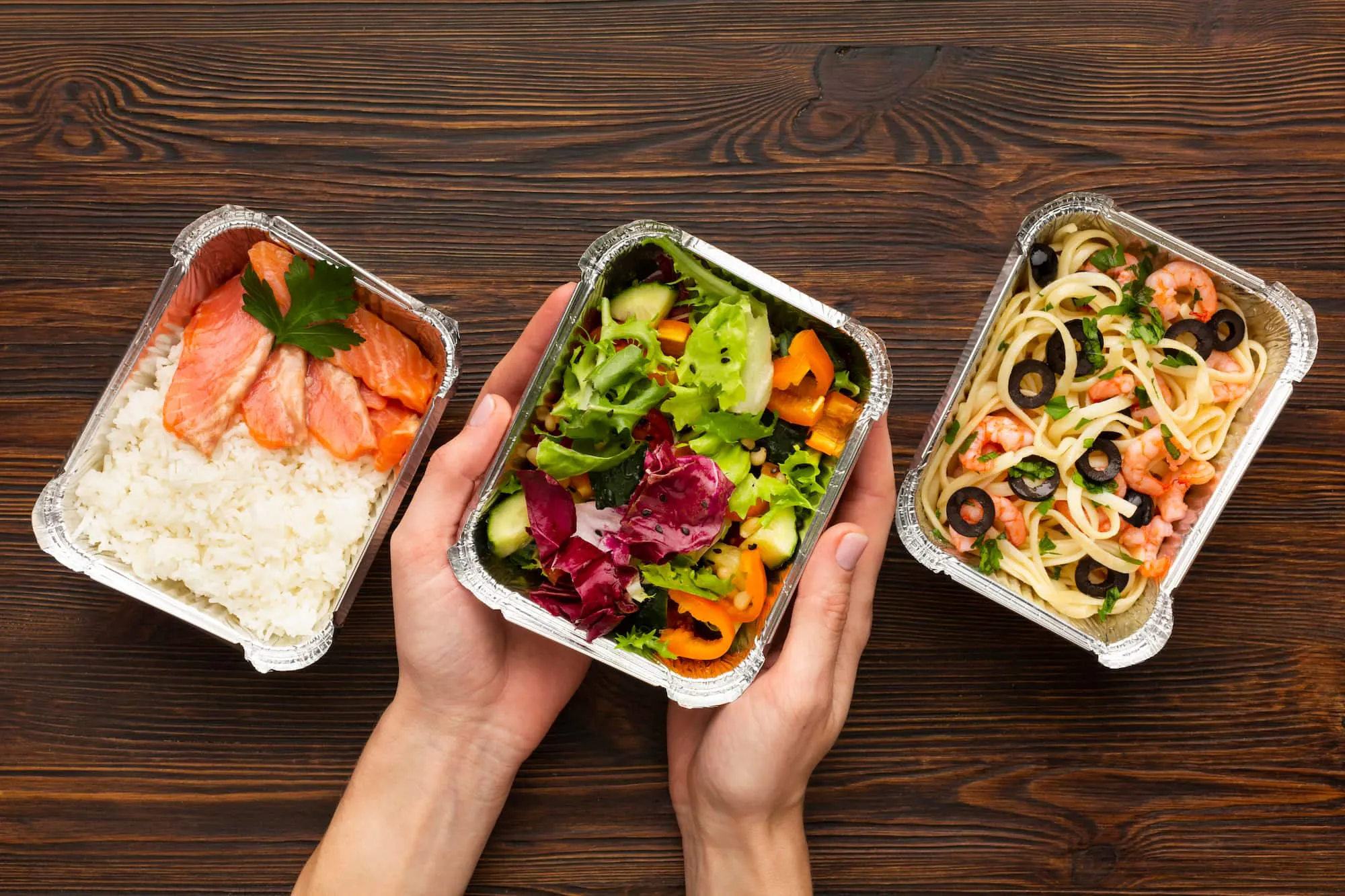 Healthy lunch options in takeout containers illustrating centralized meal ordering benefits for convenience and variety.