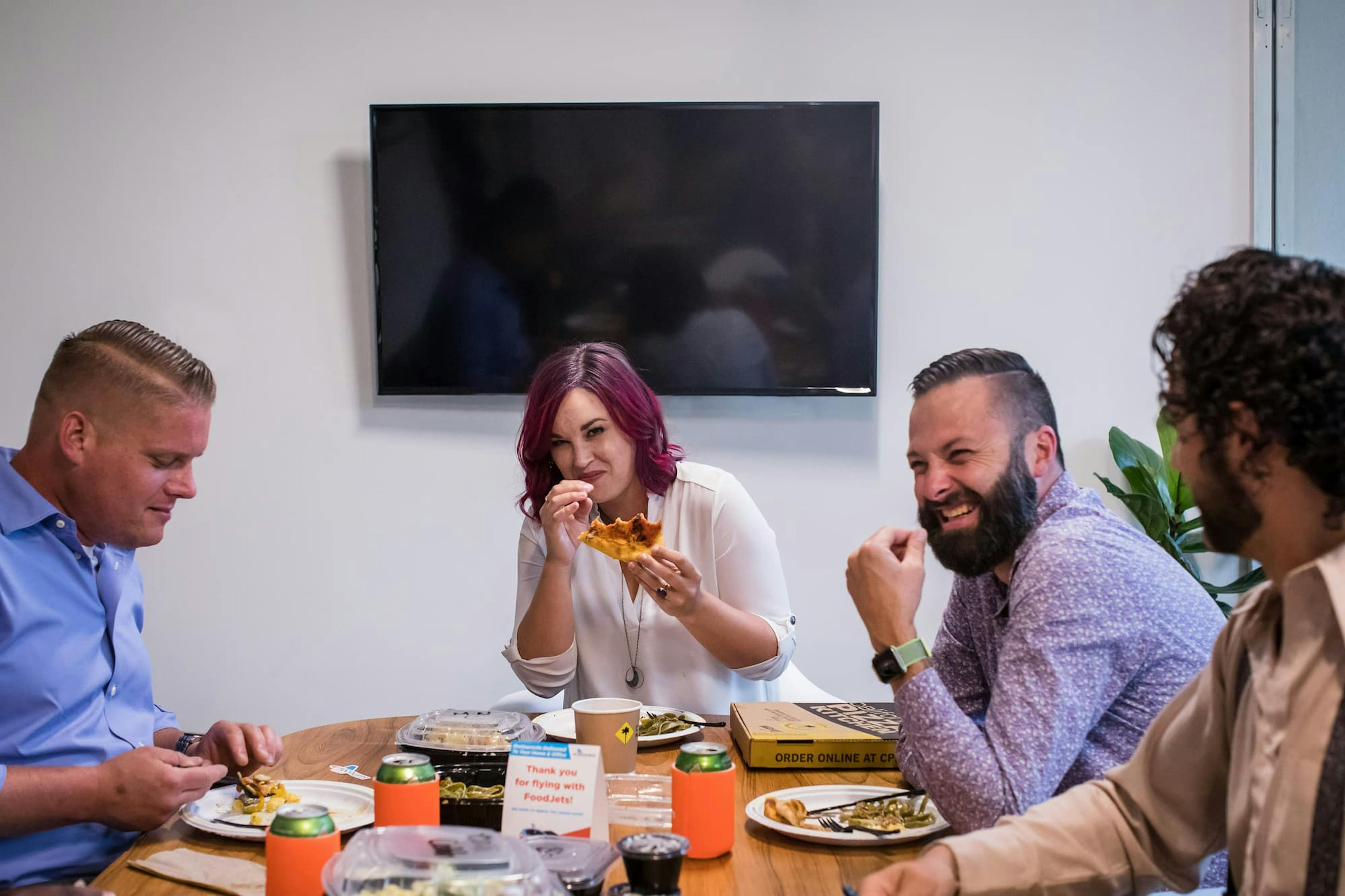 Coworkers enjoying lunch together at the office, showing why choosing Picnic for group ordering makes shared meals easy and fun.