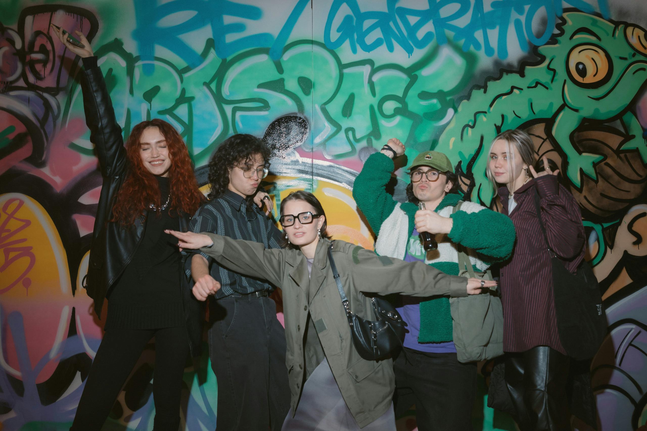 young people posing in front of ArtSpace graffiti wall