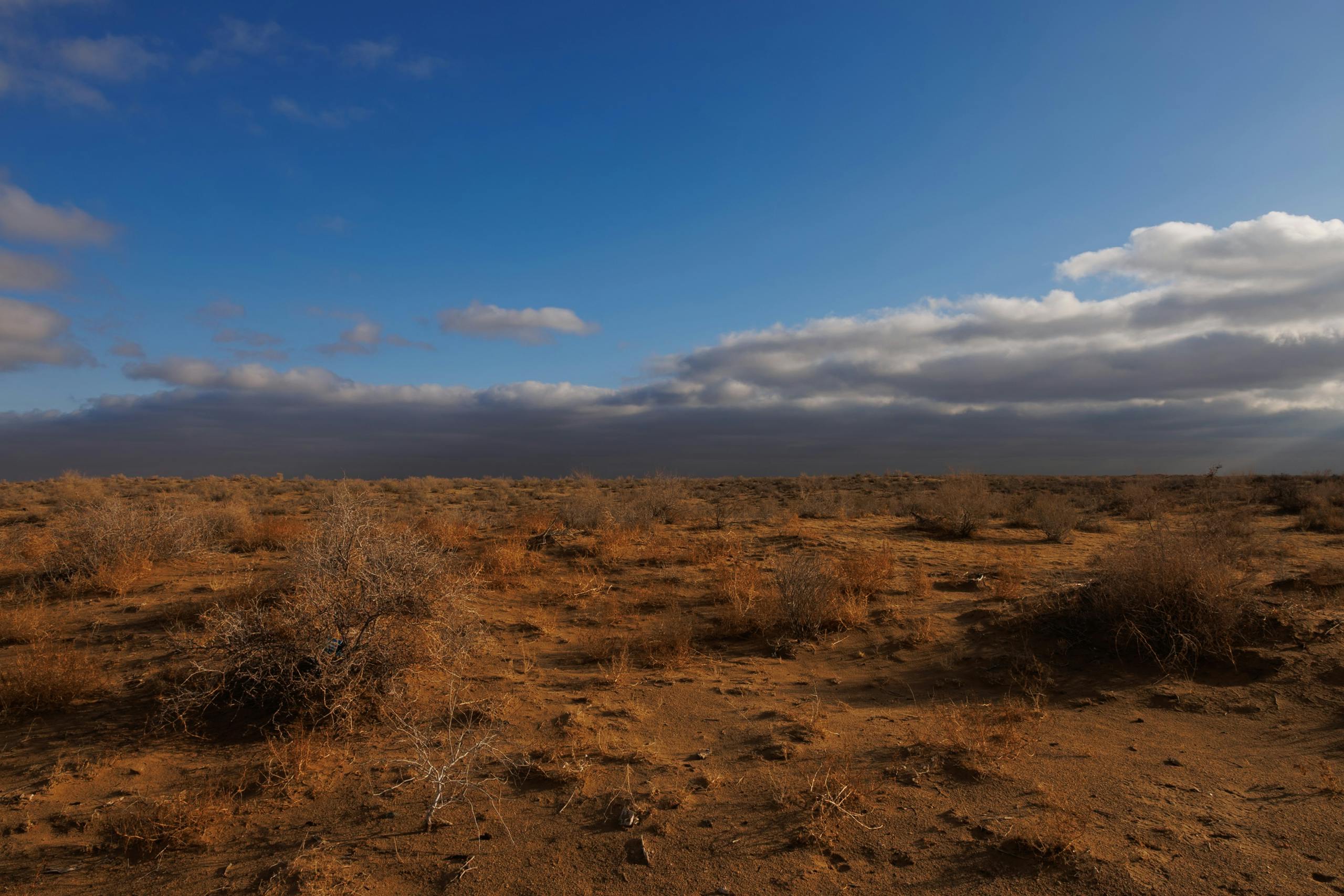 Dry desert plain landscape with clouds