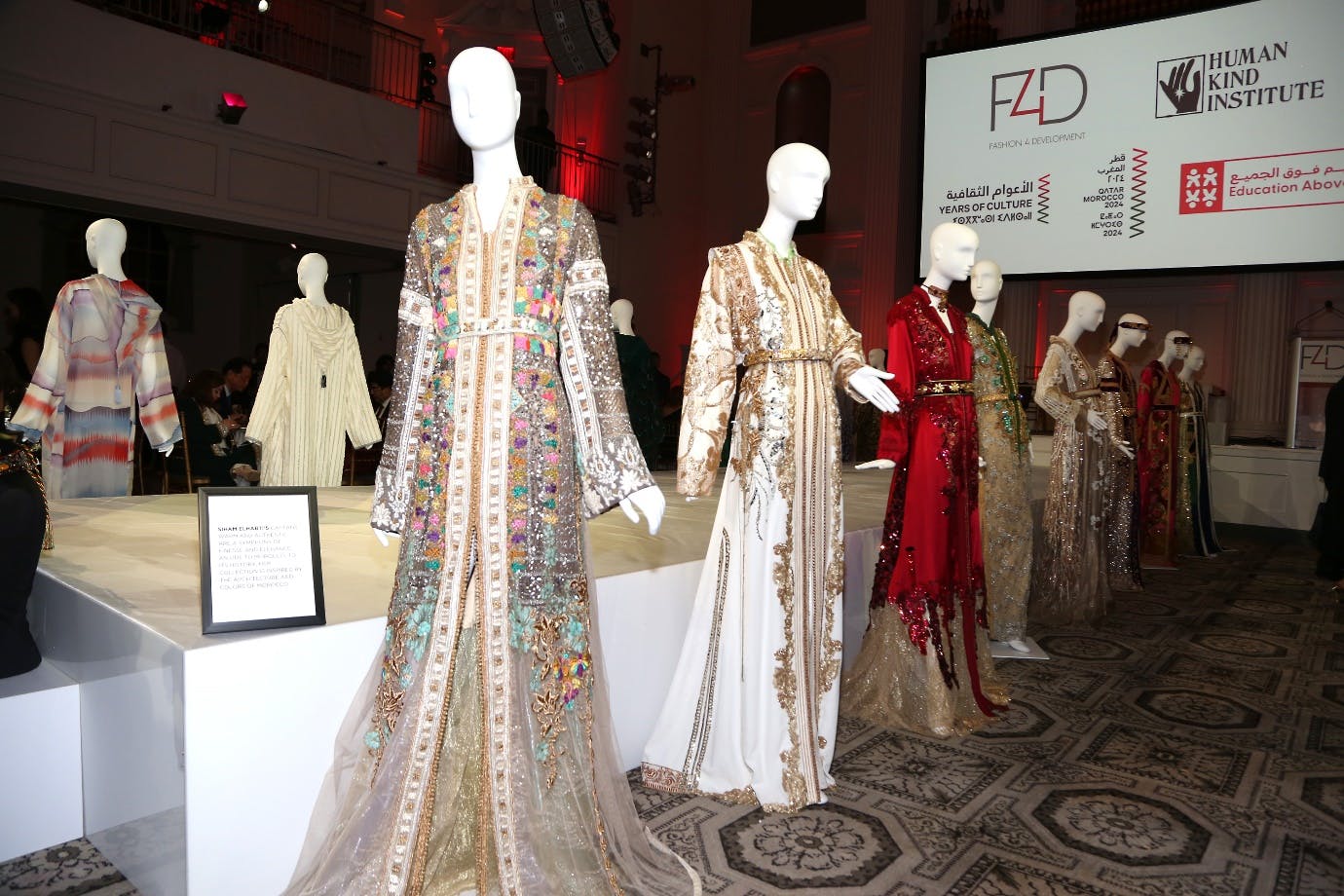 EAA Weaving Hopes Exhibition dresses in front of F4D and HKI logo background