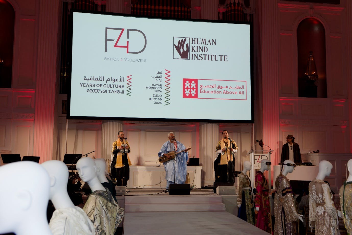 Musicians play on stage in front of F4D and HKI logos