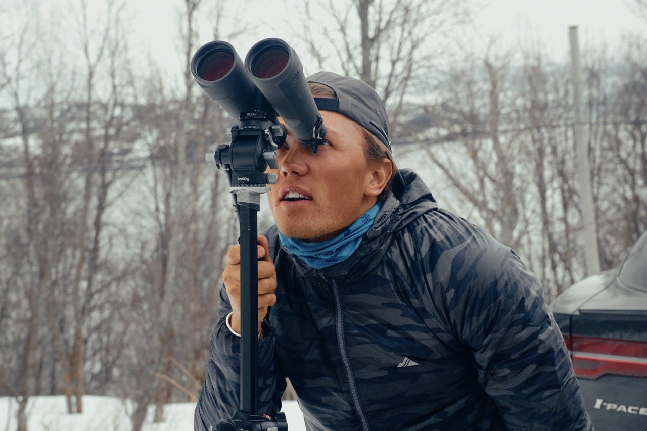 A man starting through binoculars