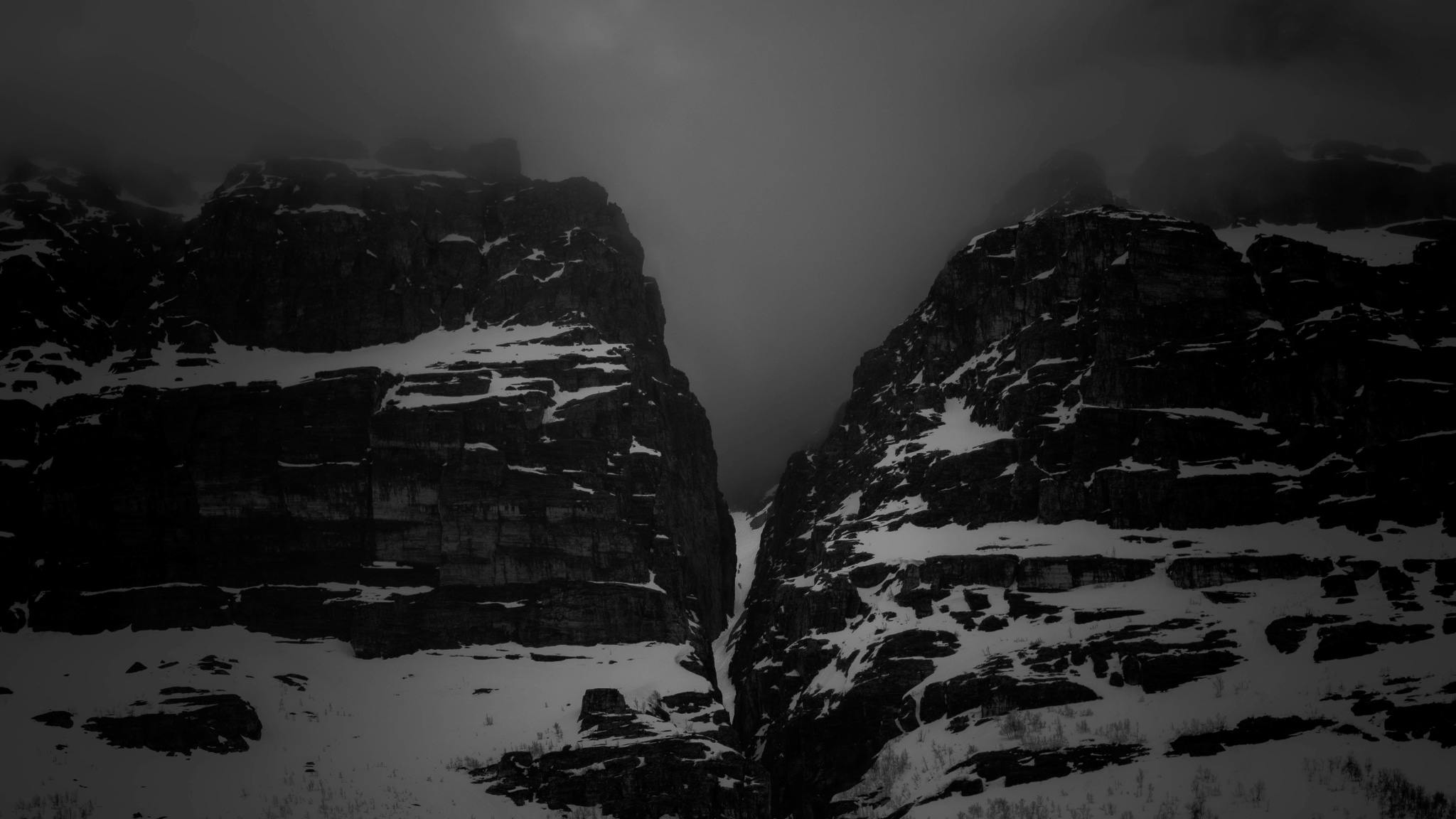 A black and white photo of a couloir between two mountains