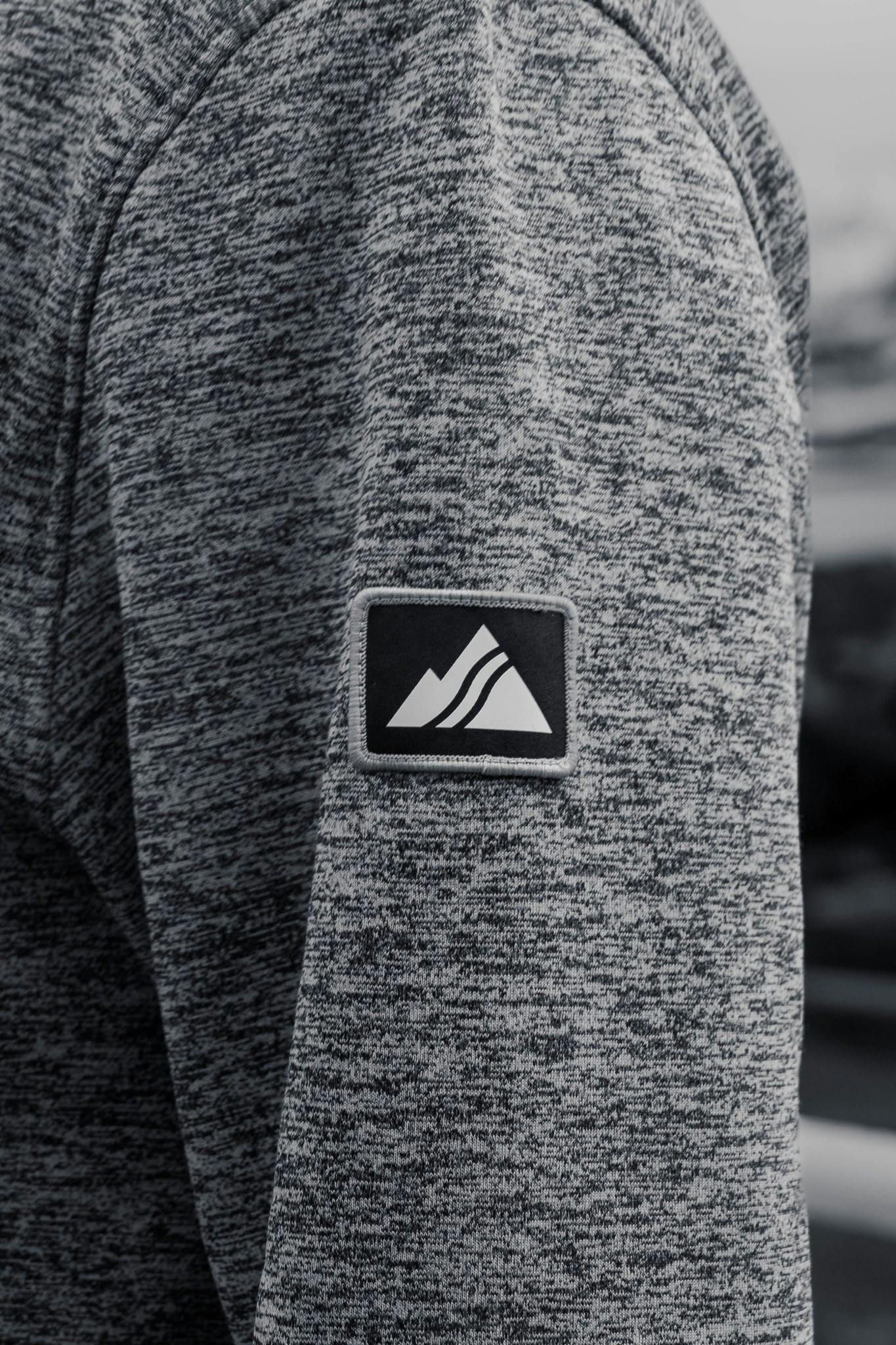 A sweater with the Strafe outerwear logo on the left arm