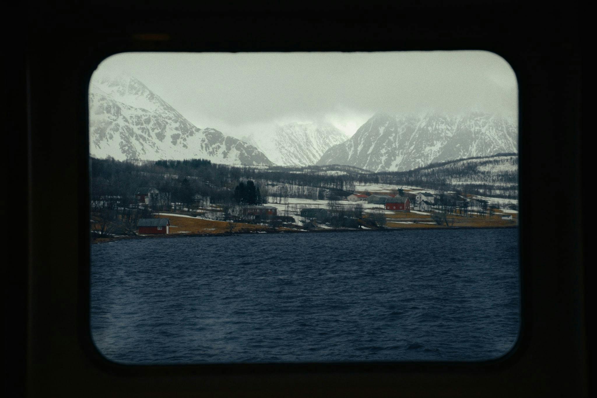 A view of mountains from the winow of a boat
