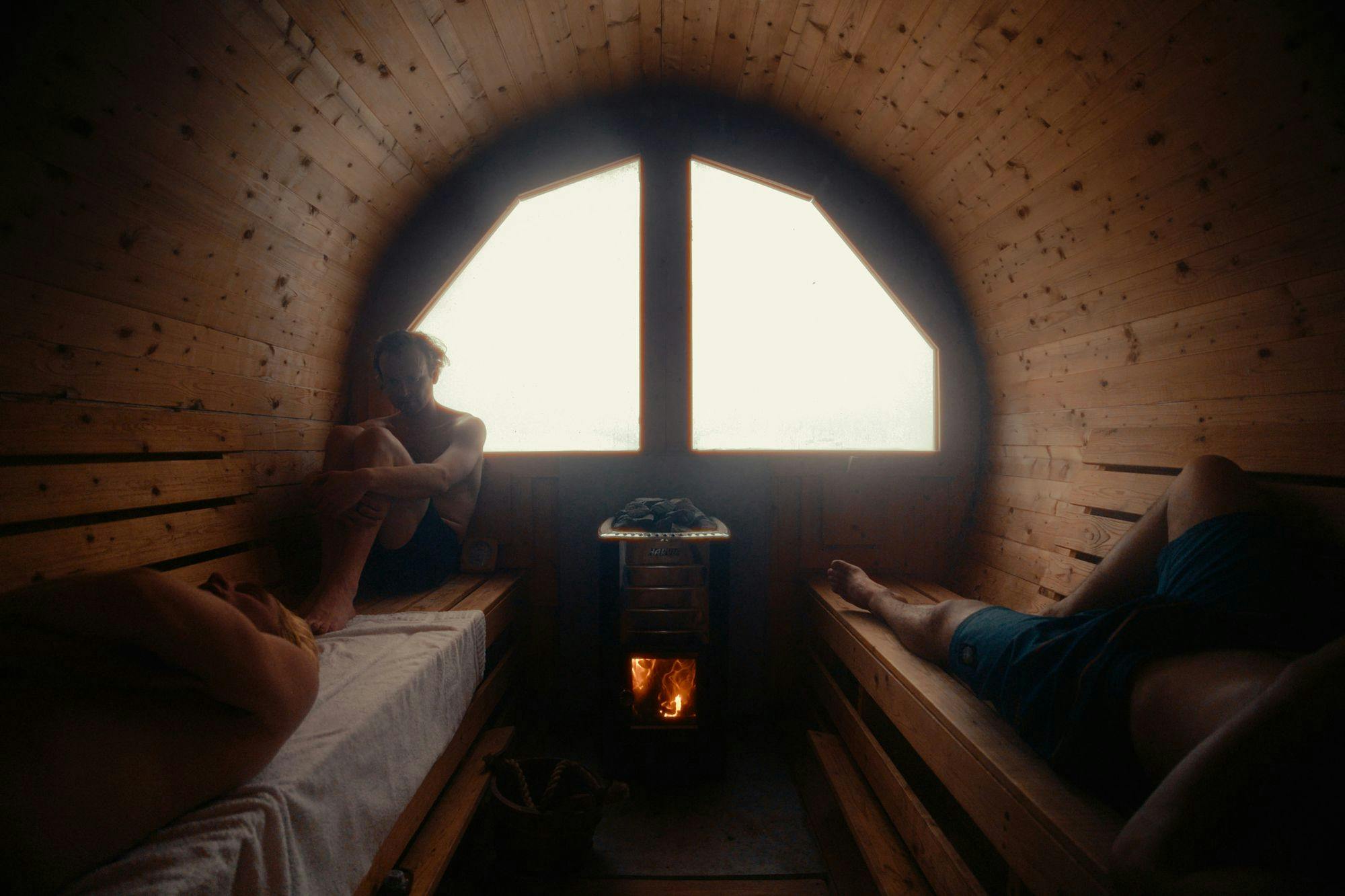 The inside of a sauna with a fire going