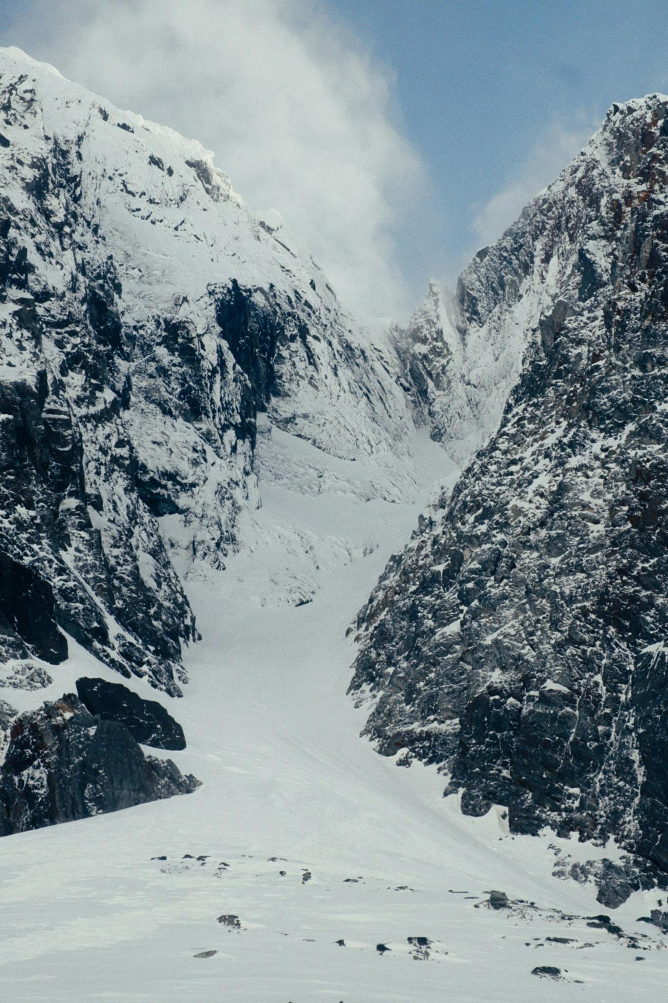 A photo of a rocky, icy couloir