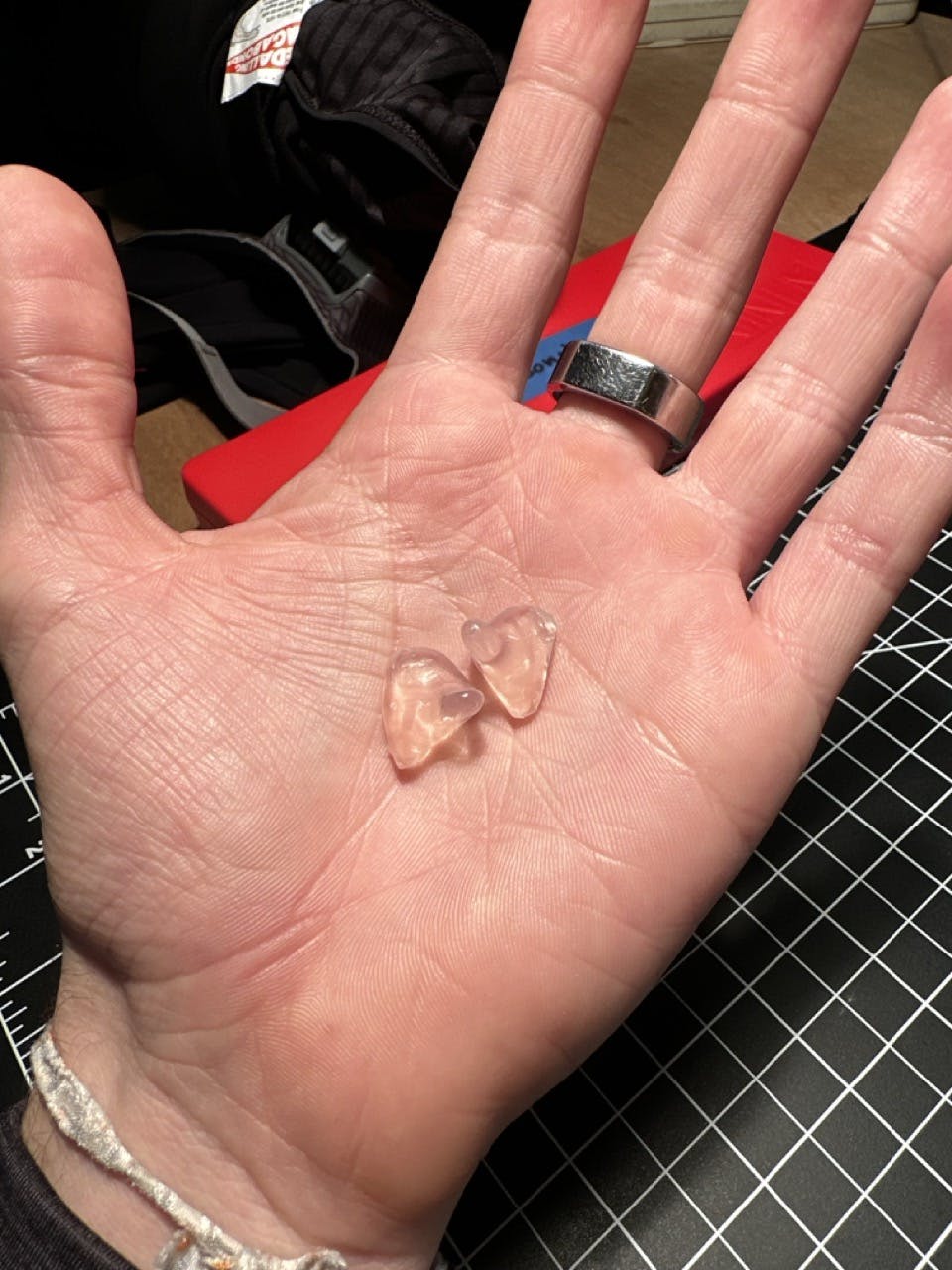 A photo of two ear plugs in a palm of a hand