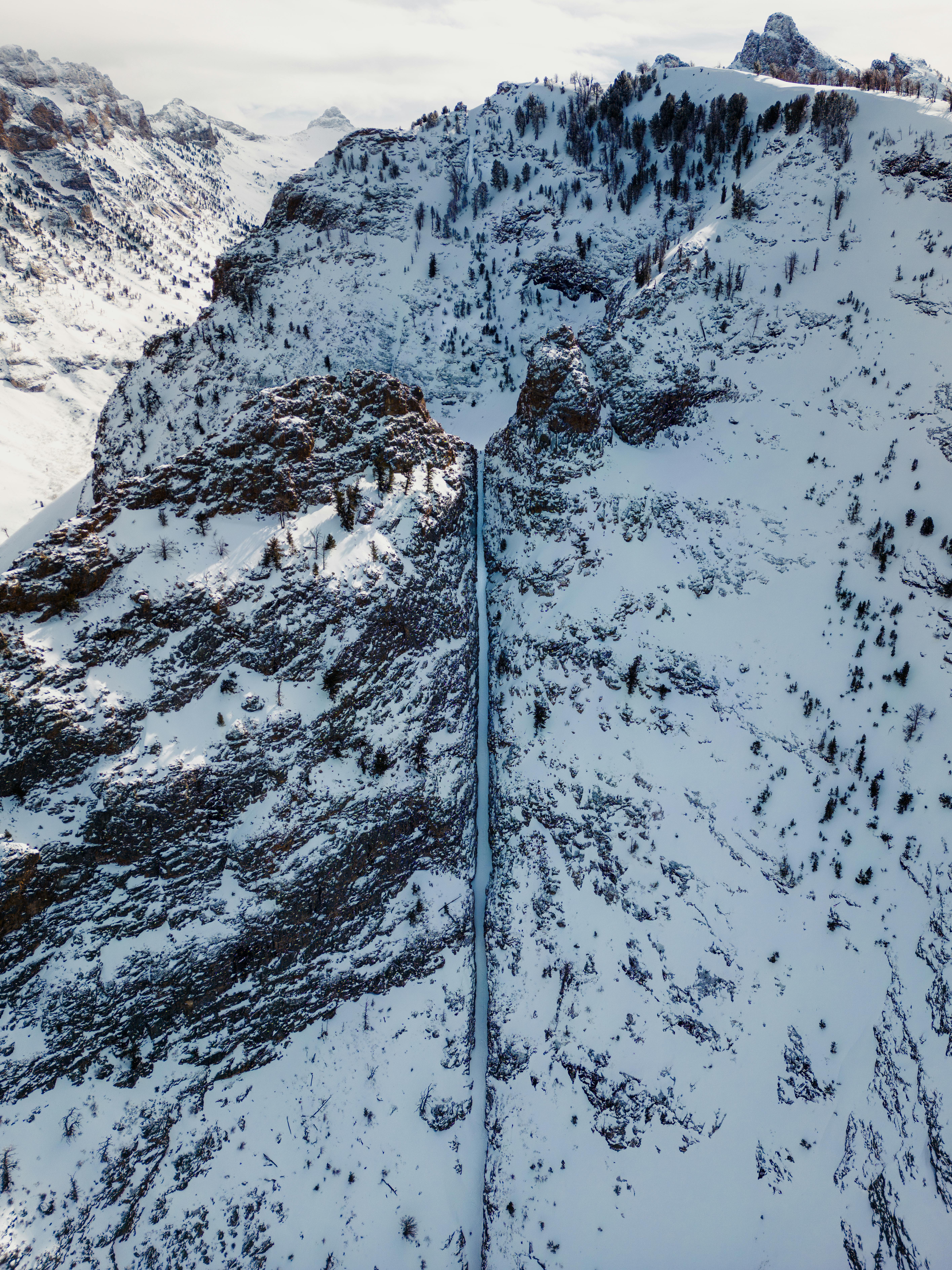 A photo of a dramatic mountain couloir from above