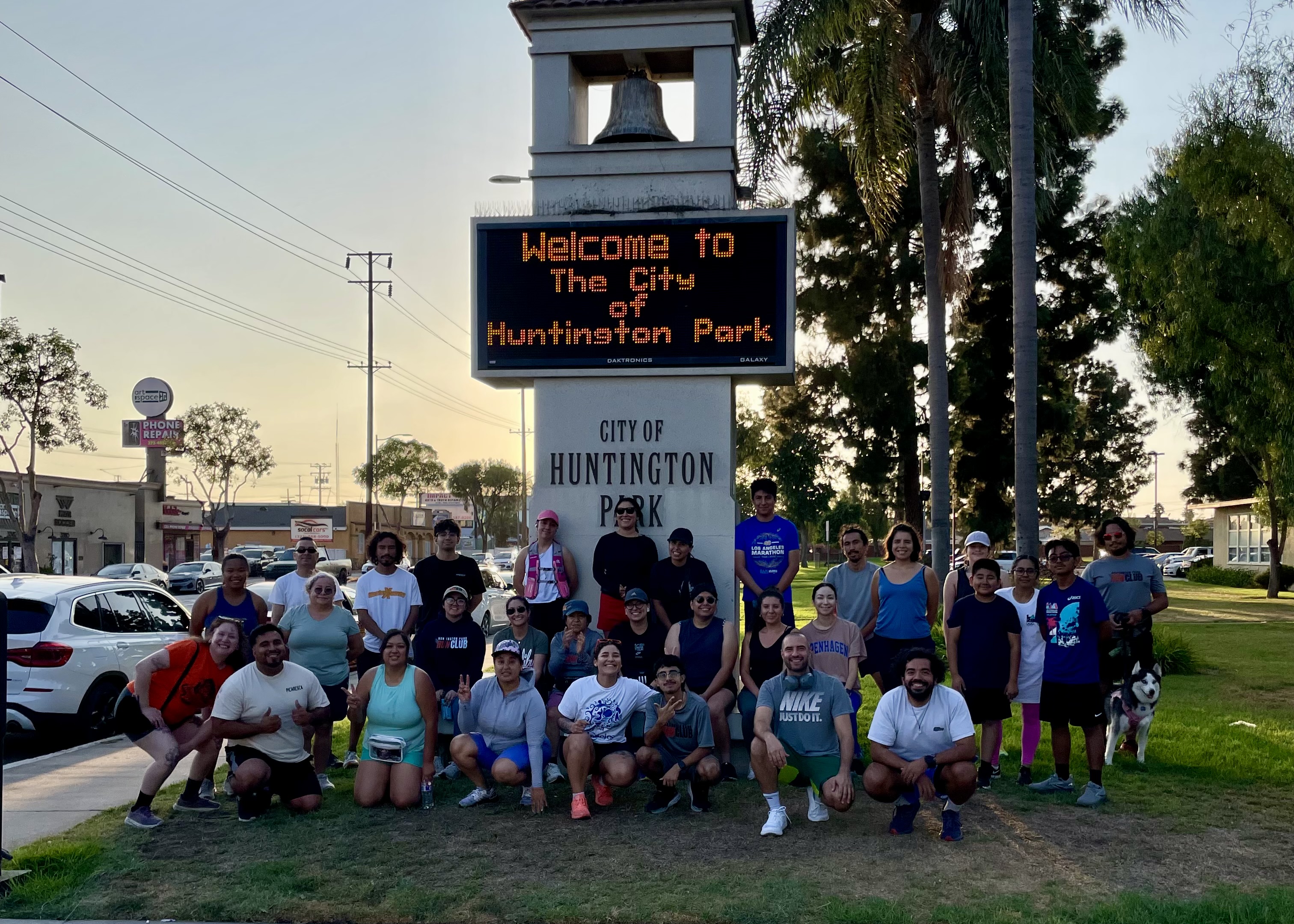 Huntington Park Run Club group photo in front of Salt Lake Park sign
