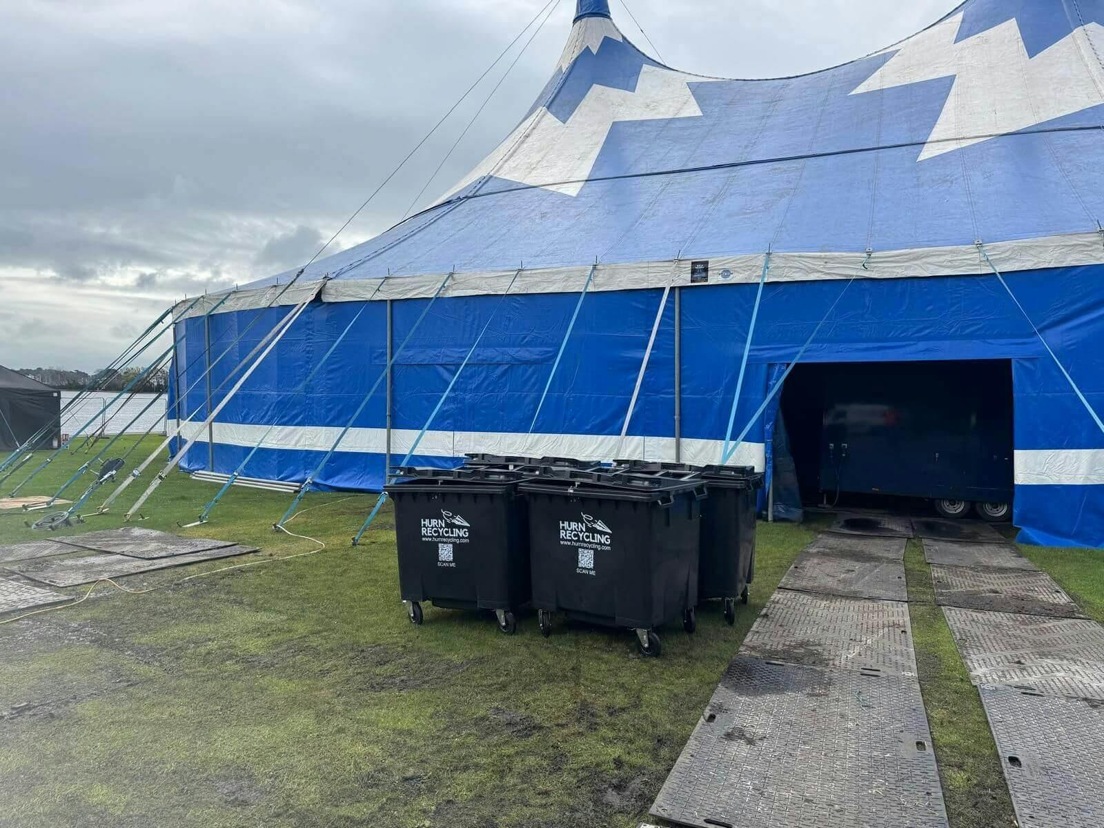 Tent behind waste bins