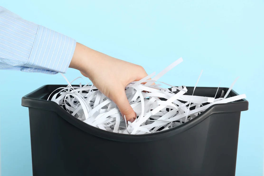 lady hand in confidential waste bin