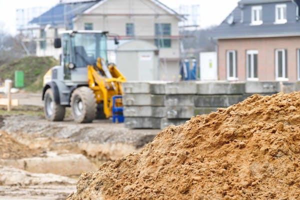 Graafmachine, zand en betonnen blokken