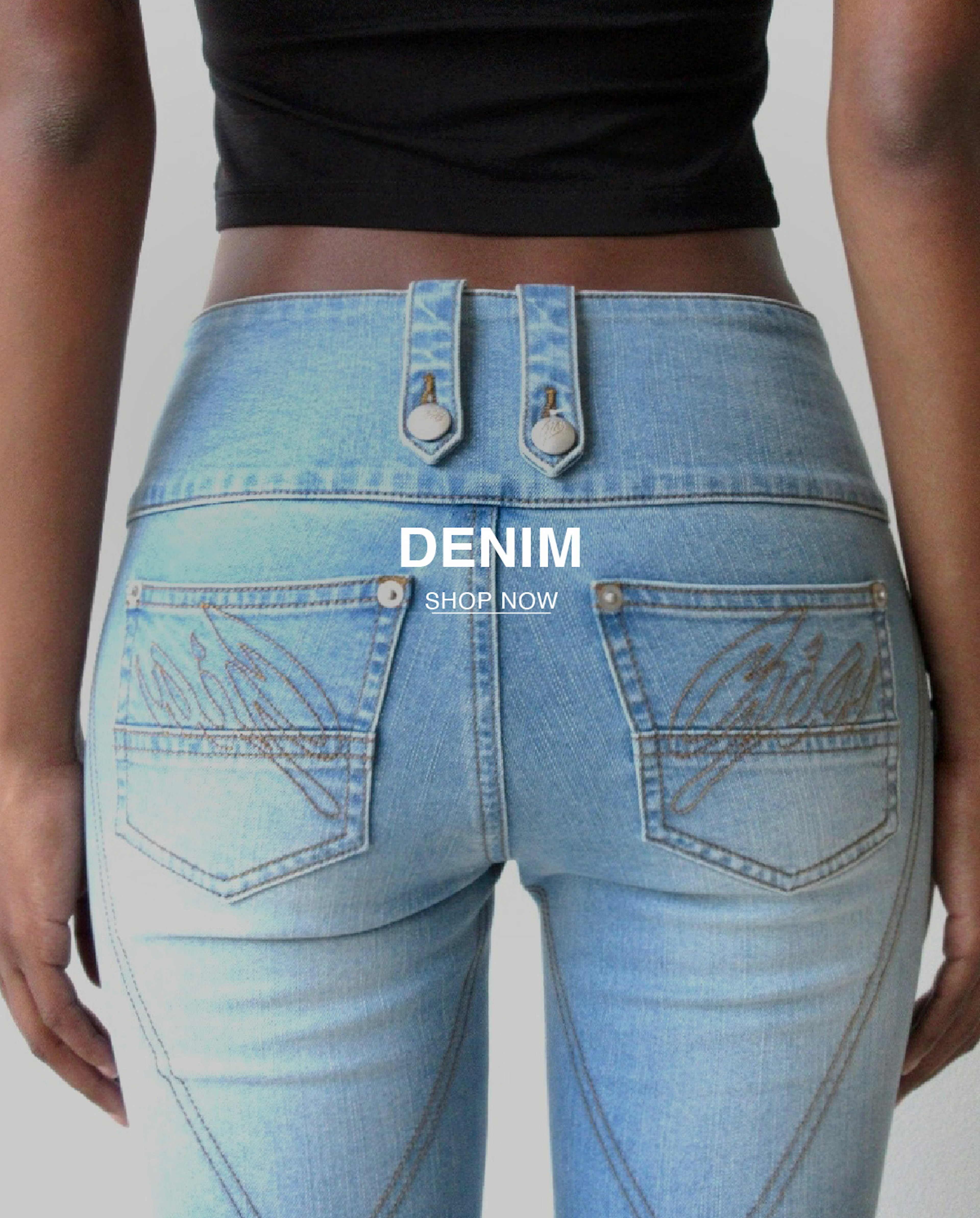 model has back towards viewer to show off denim pocket details that read "GIA"