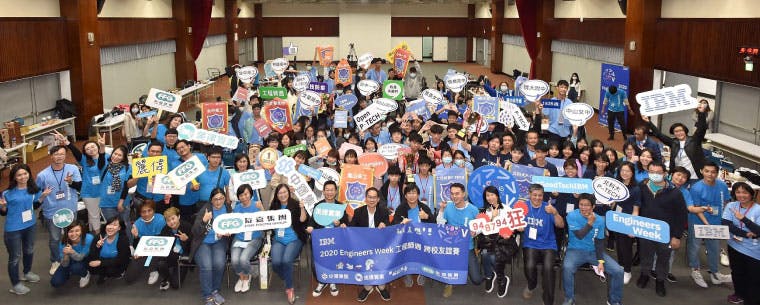 A very large group of people many holding signs that read IBM and Engineers Week