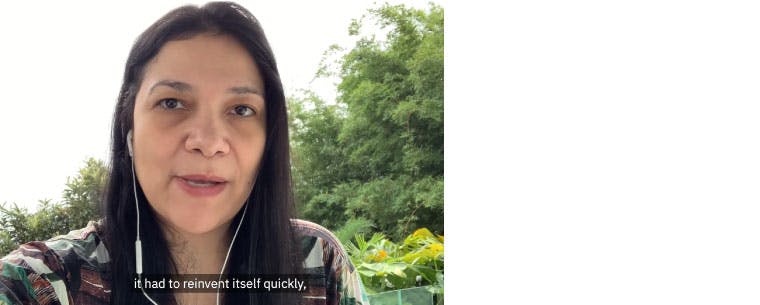 A screenshot from a video of Carolina Joaquim; trees in the background