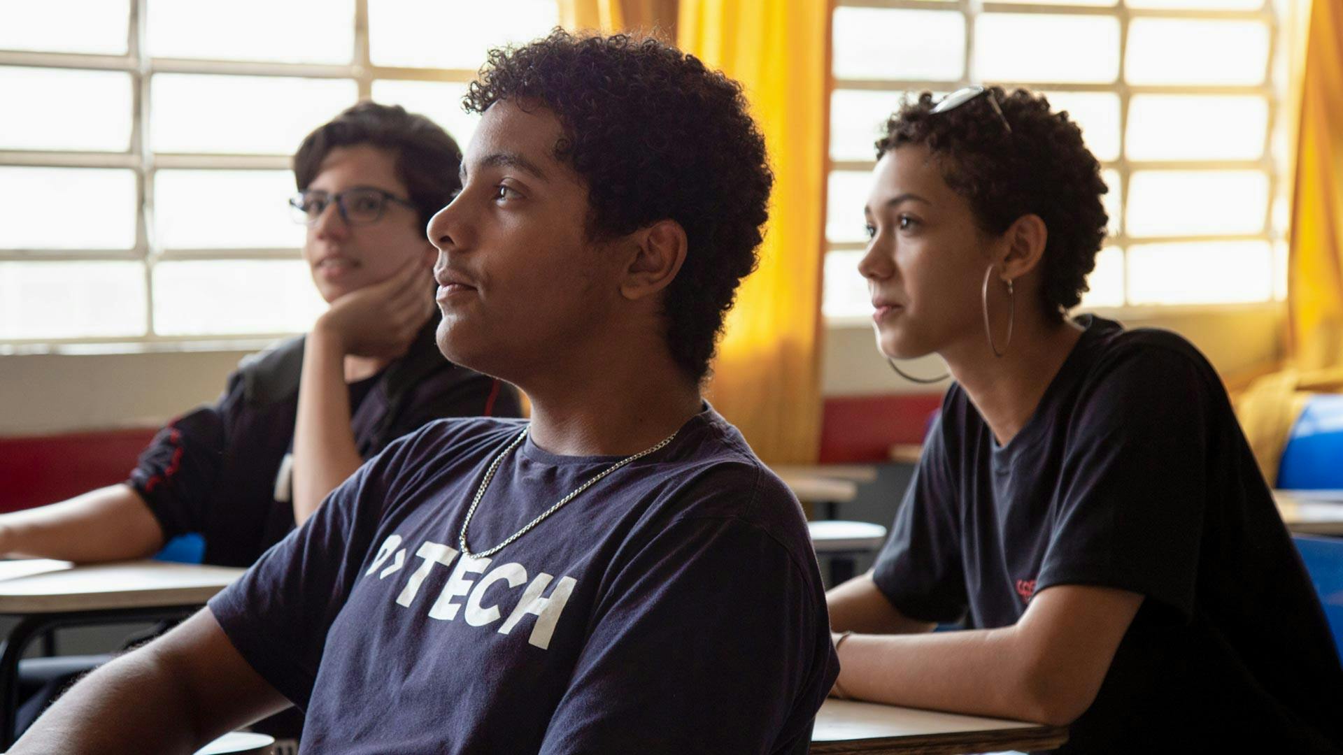 Three high school students in a P-TECH classroom in Brazil