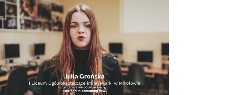 A photo of a P-TECH student, Julia Gronska, from a video. The subtitles on the screen are in Polish and English, and read: and here we could actually take part in something new. are in Polis