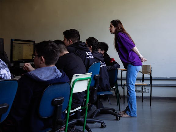 Woman teacher with students in a computer lab