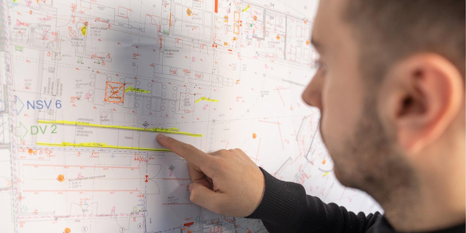 Mitarbeiter zeigt auf Projektplan Mitarbeiter zeigt auf Projektplan