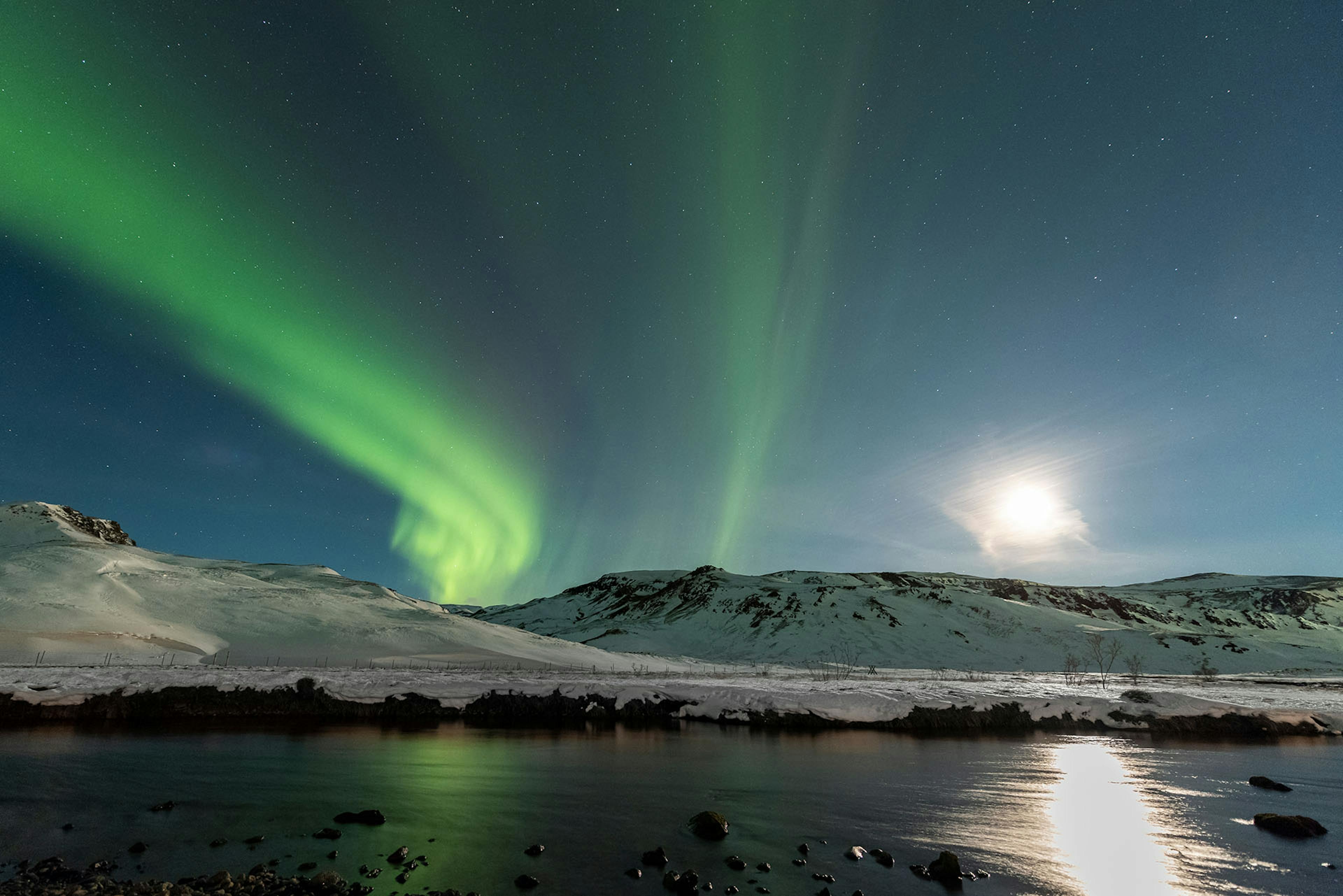 Full Moon over Reykjadalur with Northern Lights. Credit: Gísli Már Árnason