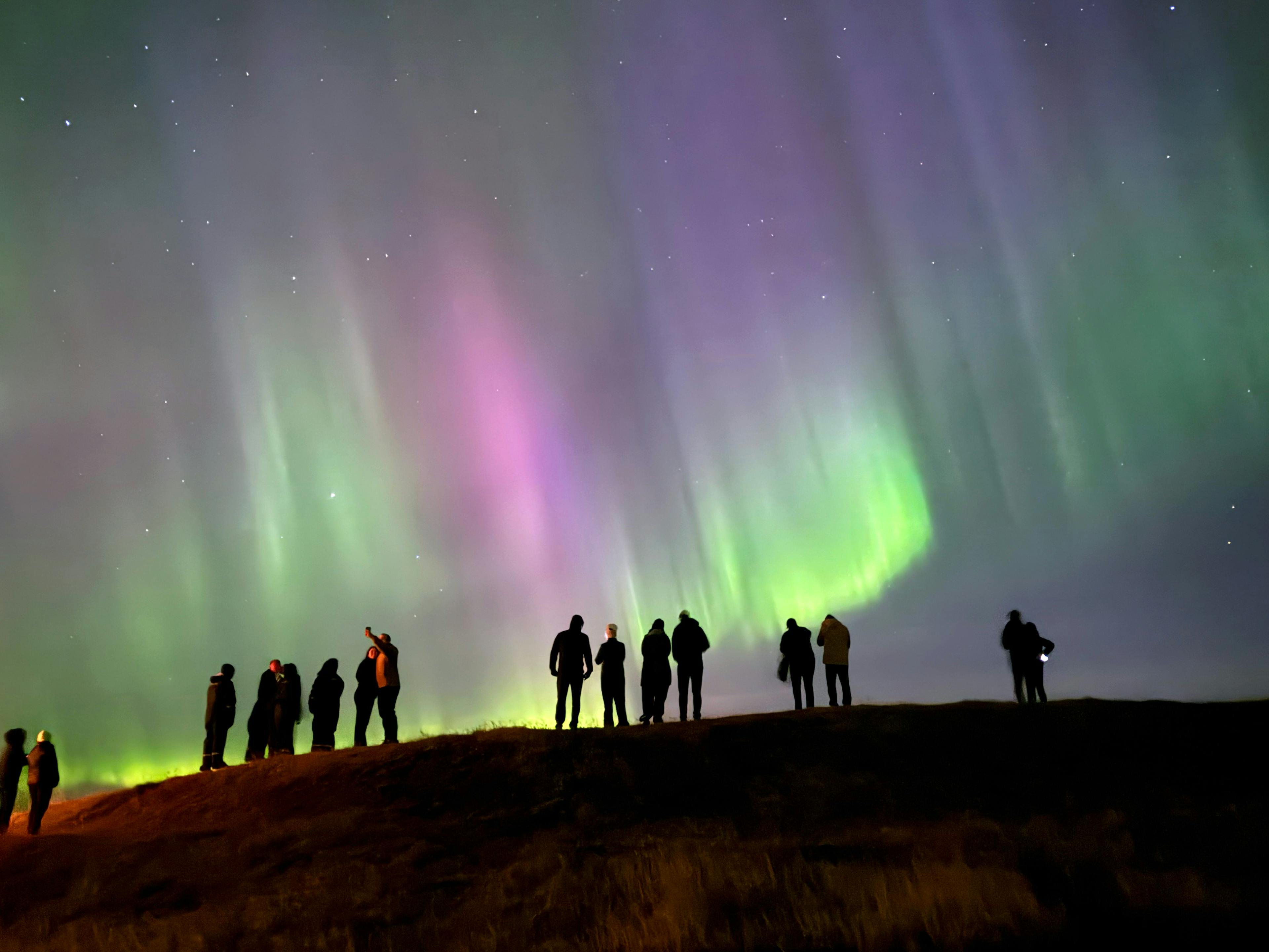 People watching and photographing the Northern Lights from Hotel Rangá in south Iceland on September 25, 2024. Shot on. Credit: Sigríður Kristjánsdóttir