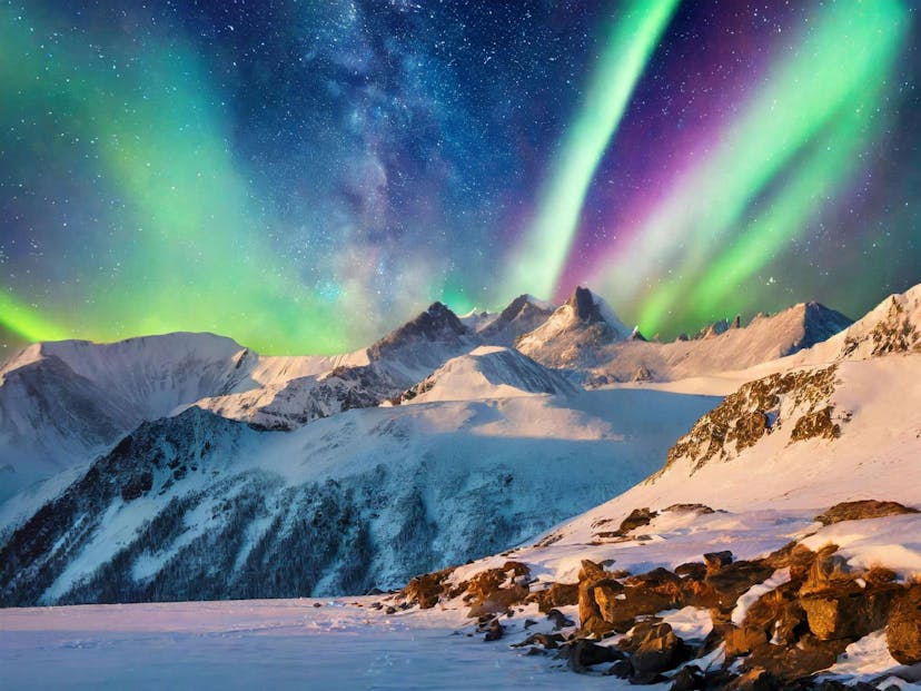 Northern lights above snowy mountains in Iceland
