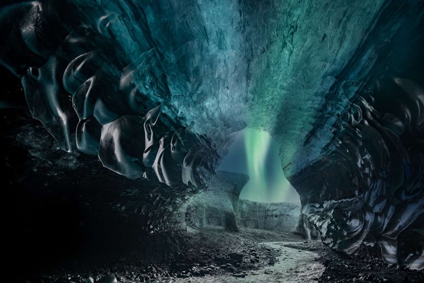 Northern lights outside of glacier cave in Iceland