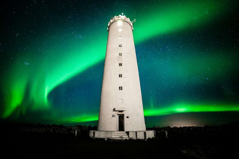 Light house in Iceland surrounded by Northern Lights