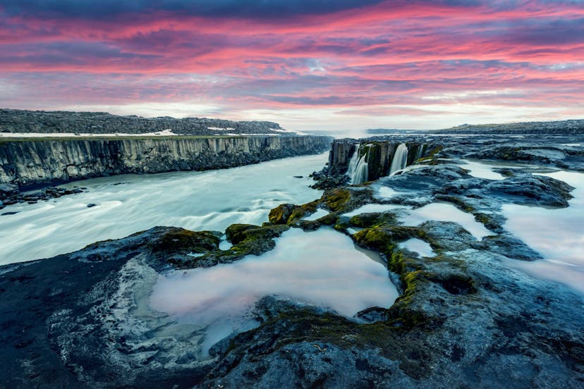 Sunset above Icelandic waterfall