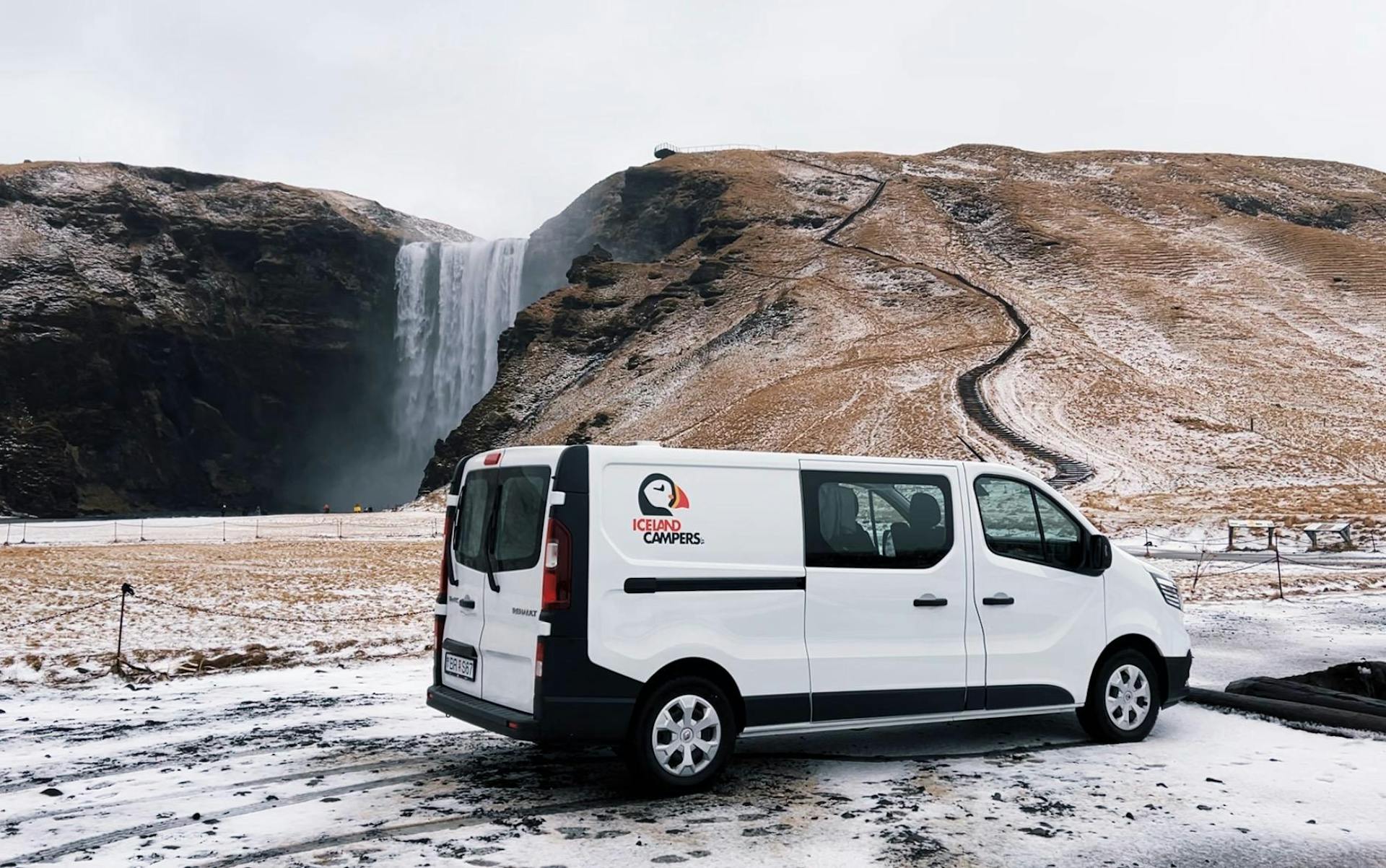 Campervan parked by Skogafoss waterfall